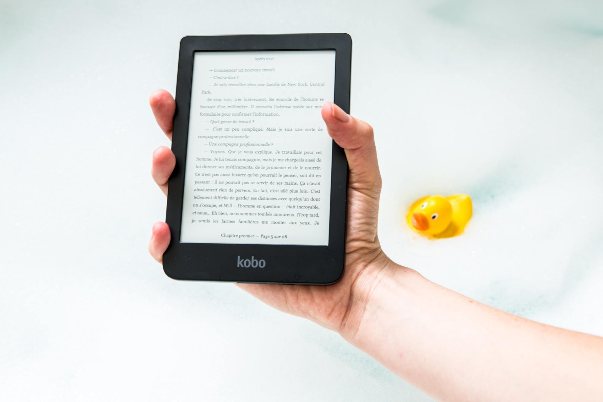 image of a hand holding a tablet to read a great peice of content