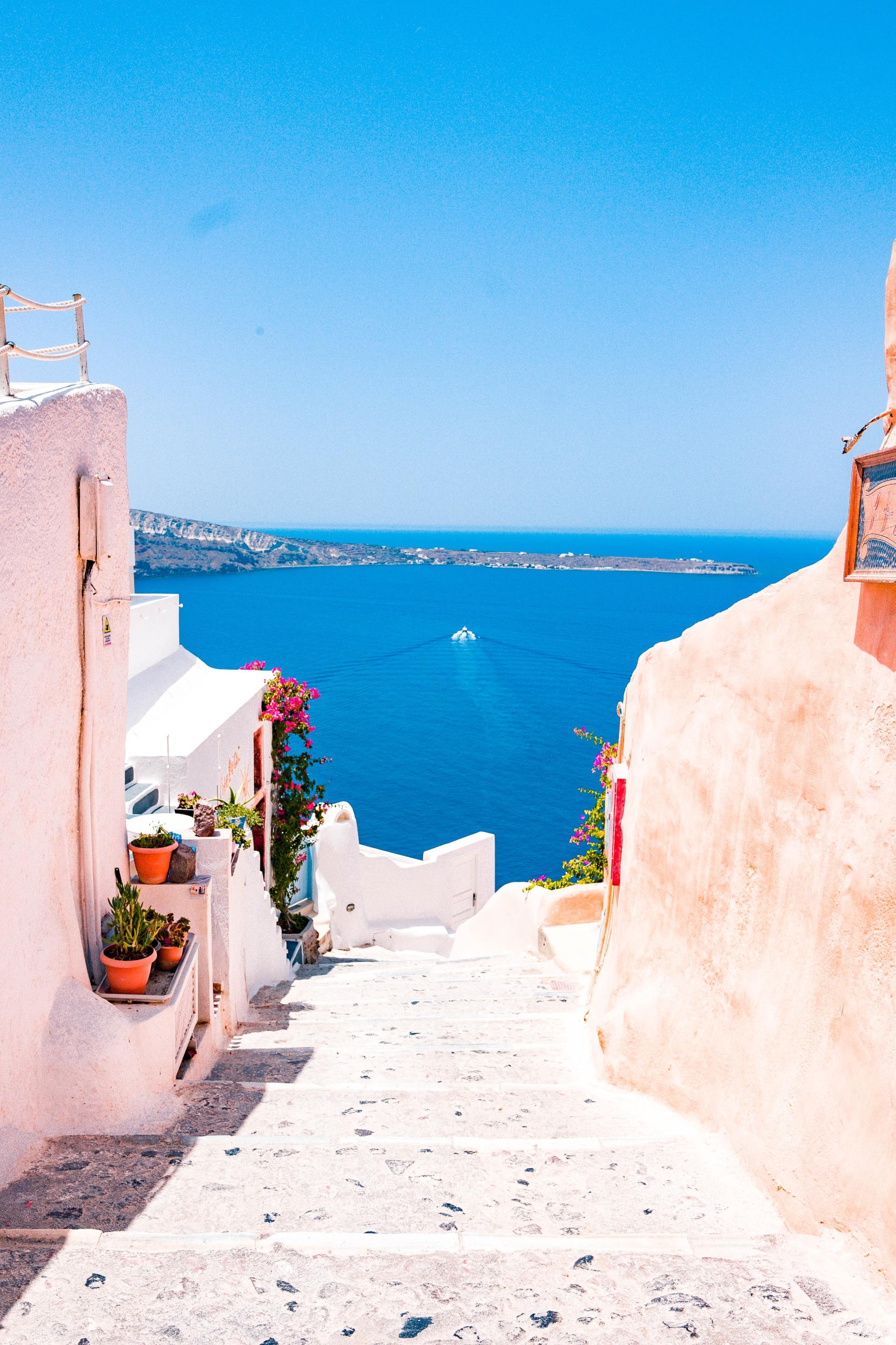 A narrow street with stairs leading up to the ocean