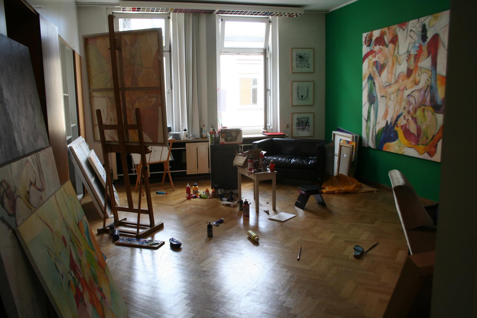 This is a photo of a living room with art pieces hanging on the walls.