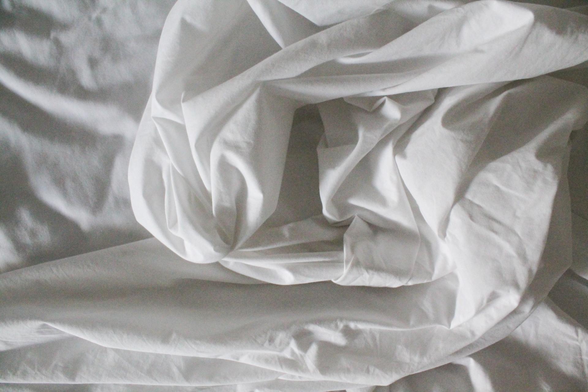 crumpled white bedsheet