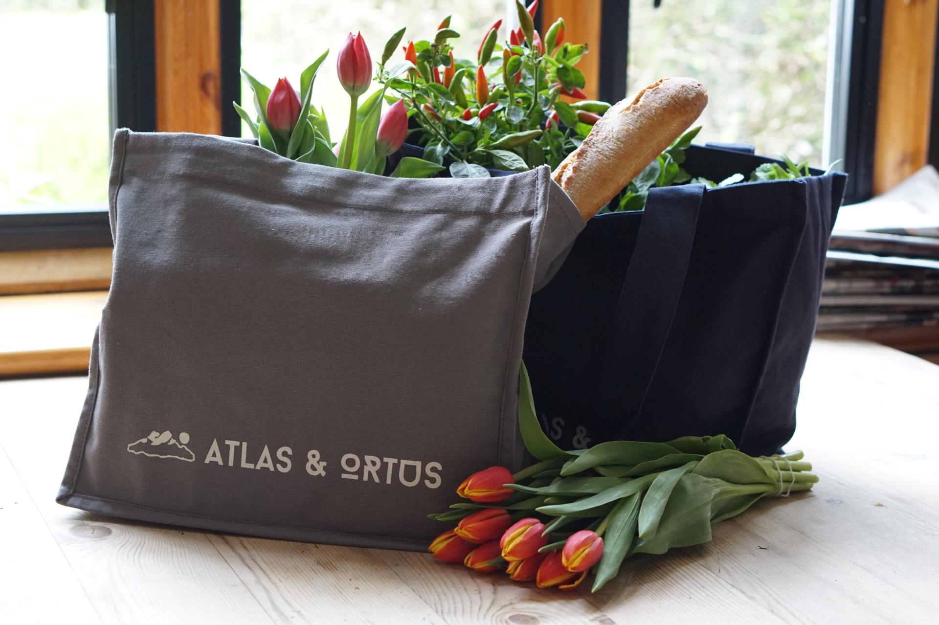 a bag that says atlas & ortos sits on a table