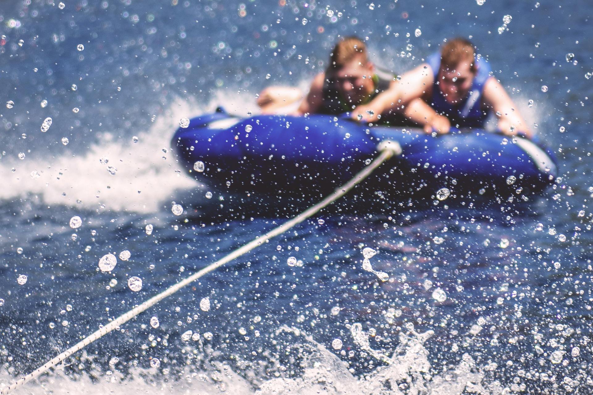 three people in a pontoon on the water