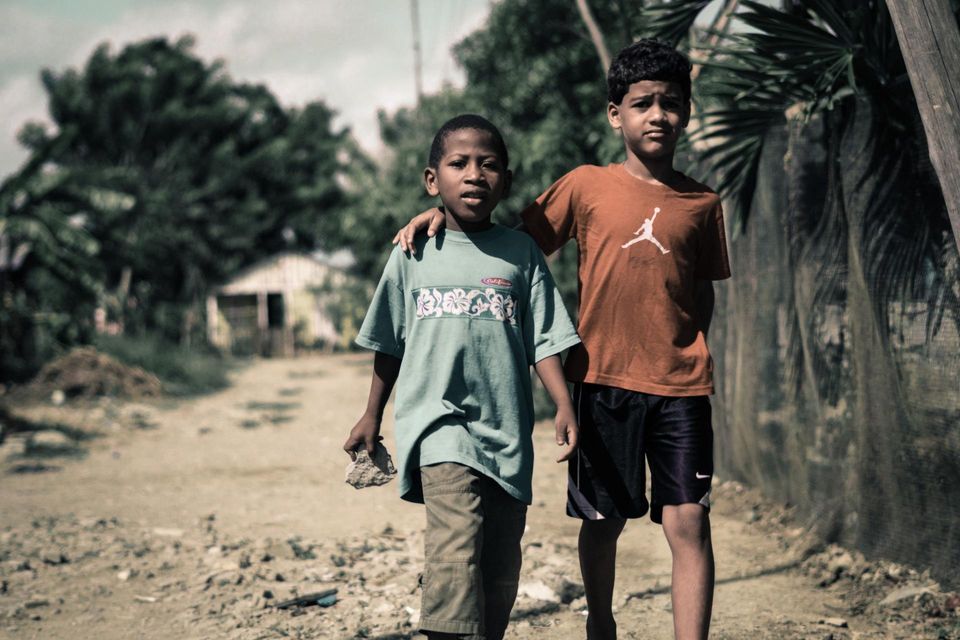Two young boys walking down street