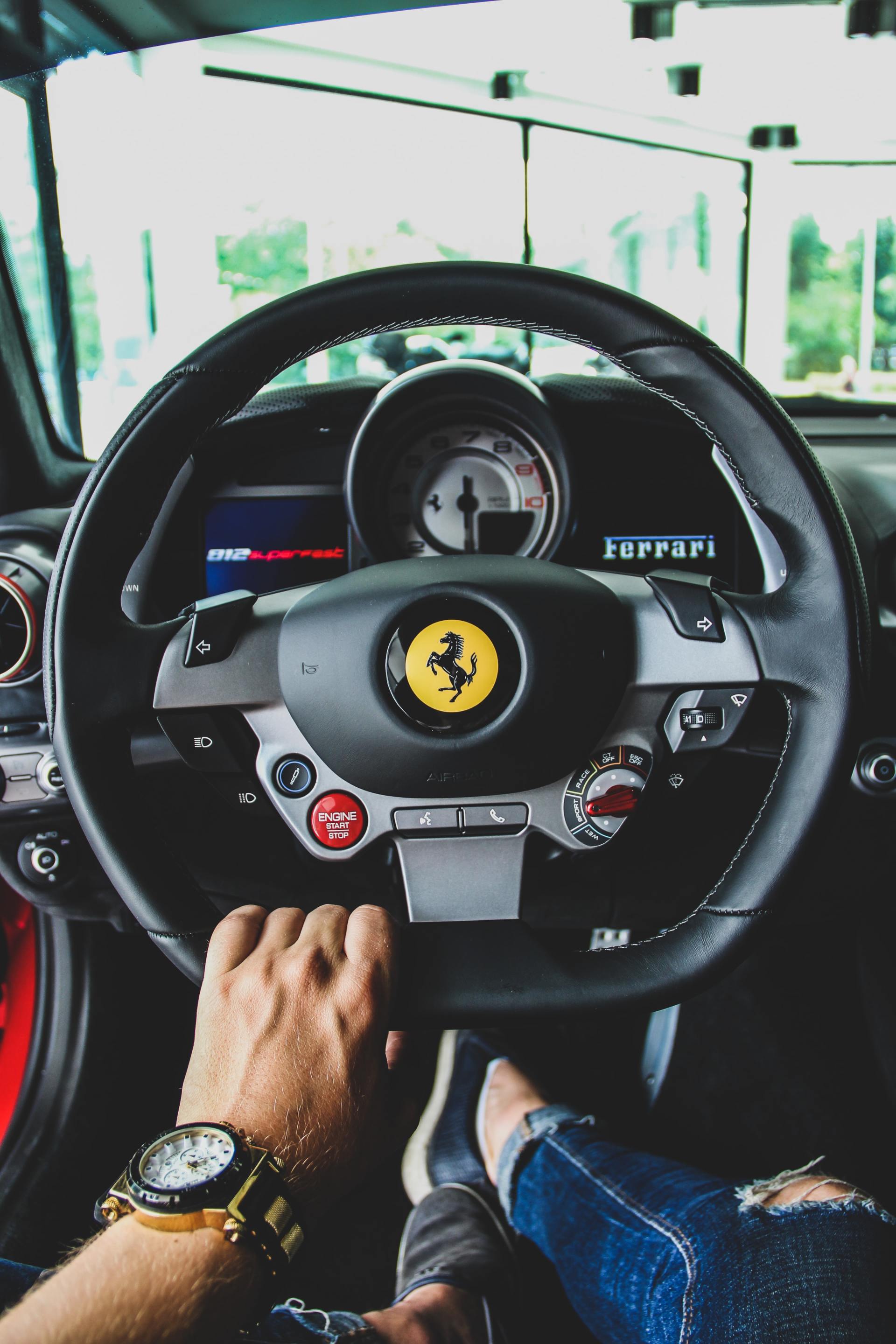 Ferrari interior with person driving
