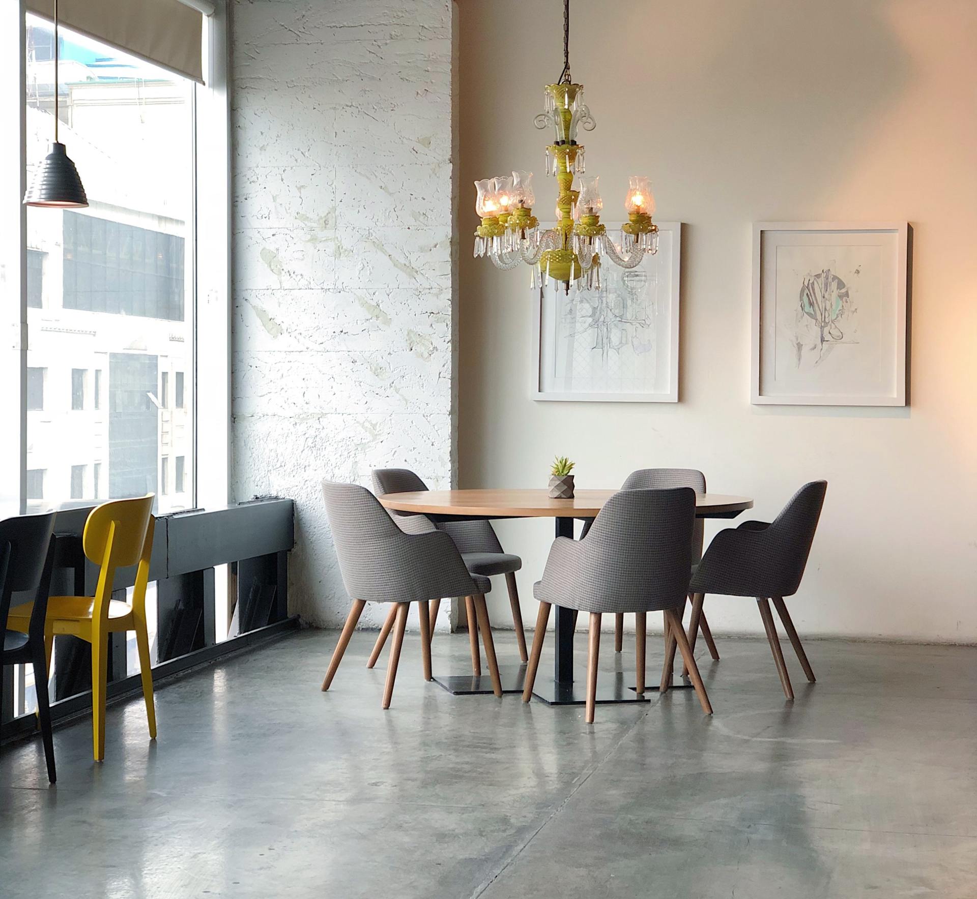 A dining room with a table and chairs and a chandelier