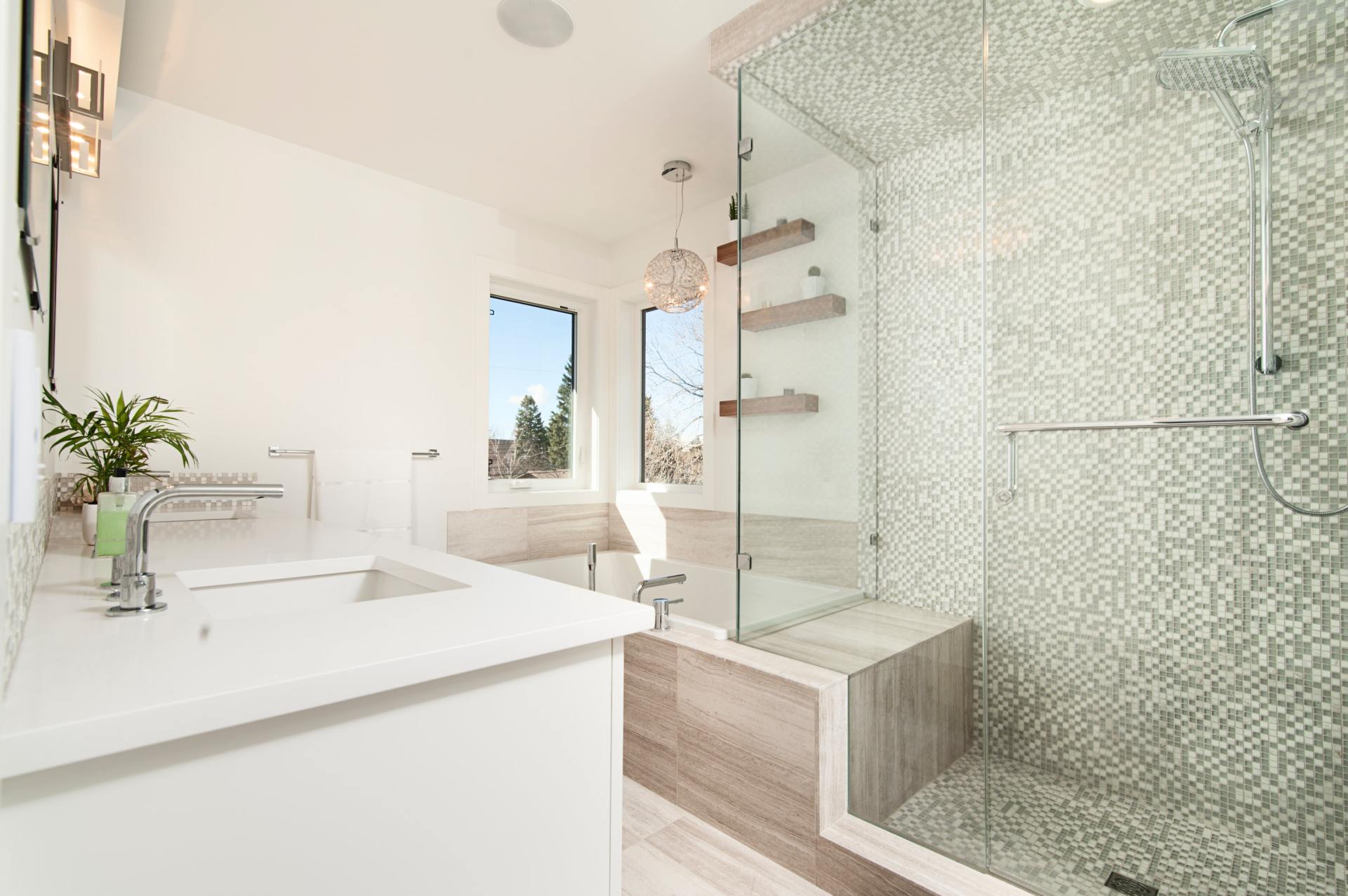 A bathroom with a walk in shower and a sink.