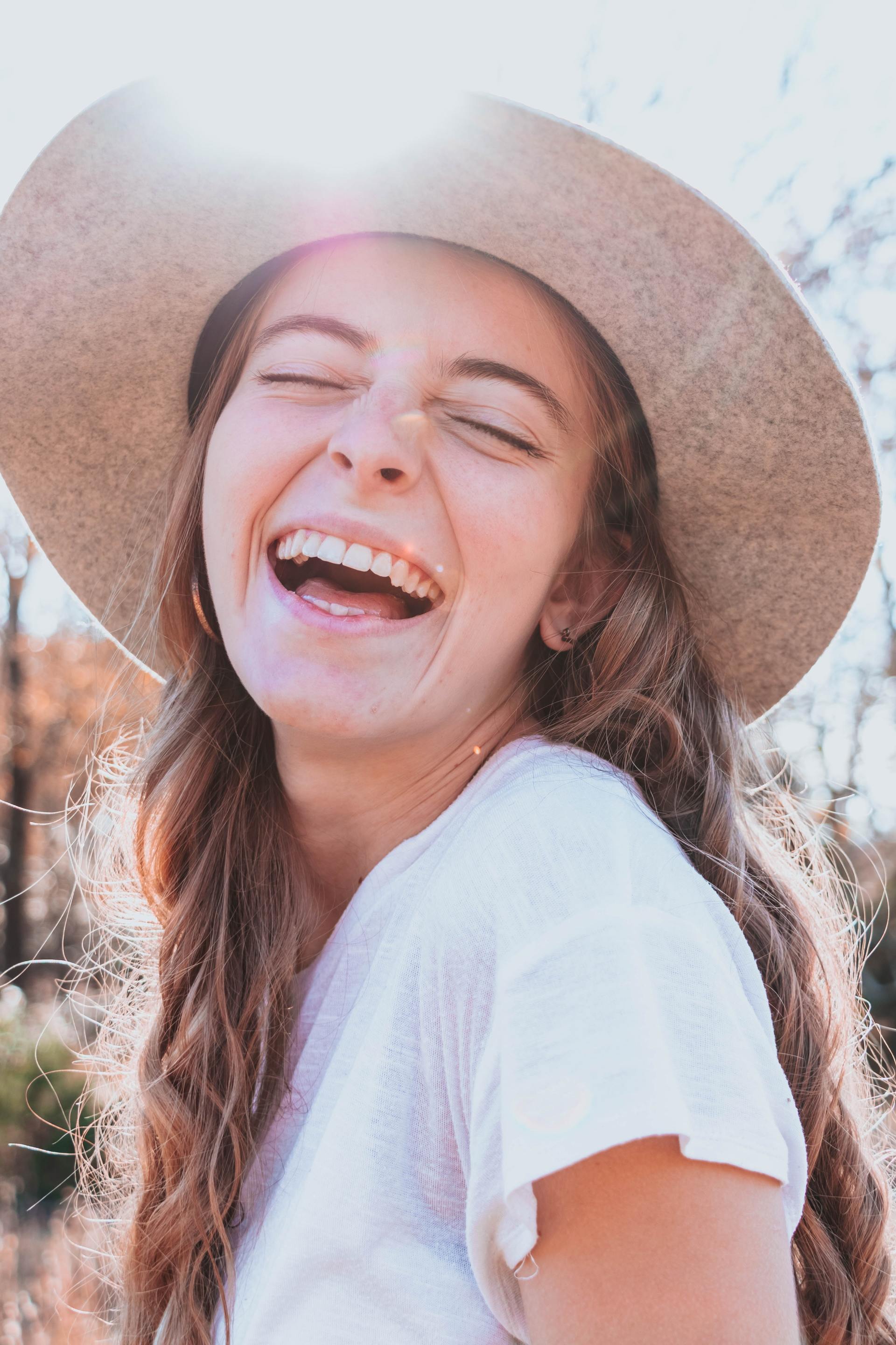 Smiling Girl in Hat at dentists in Lawrence Kansas | Get teeth whitening