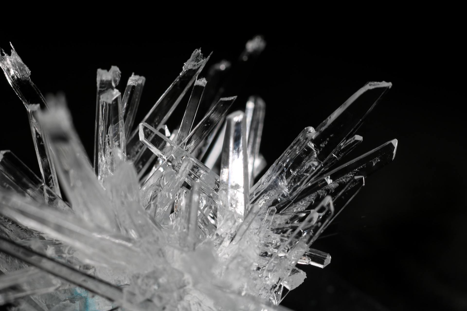 A close up of a crystal on a black background.