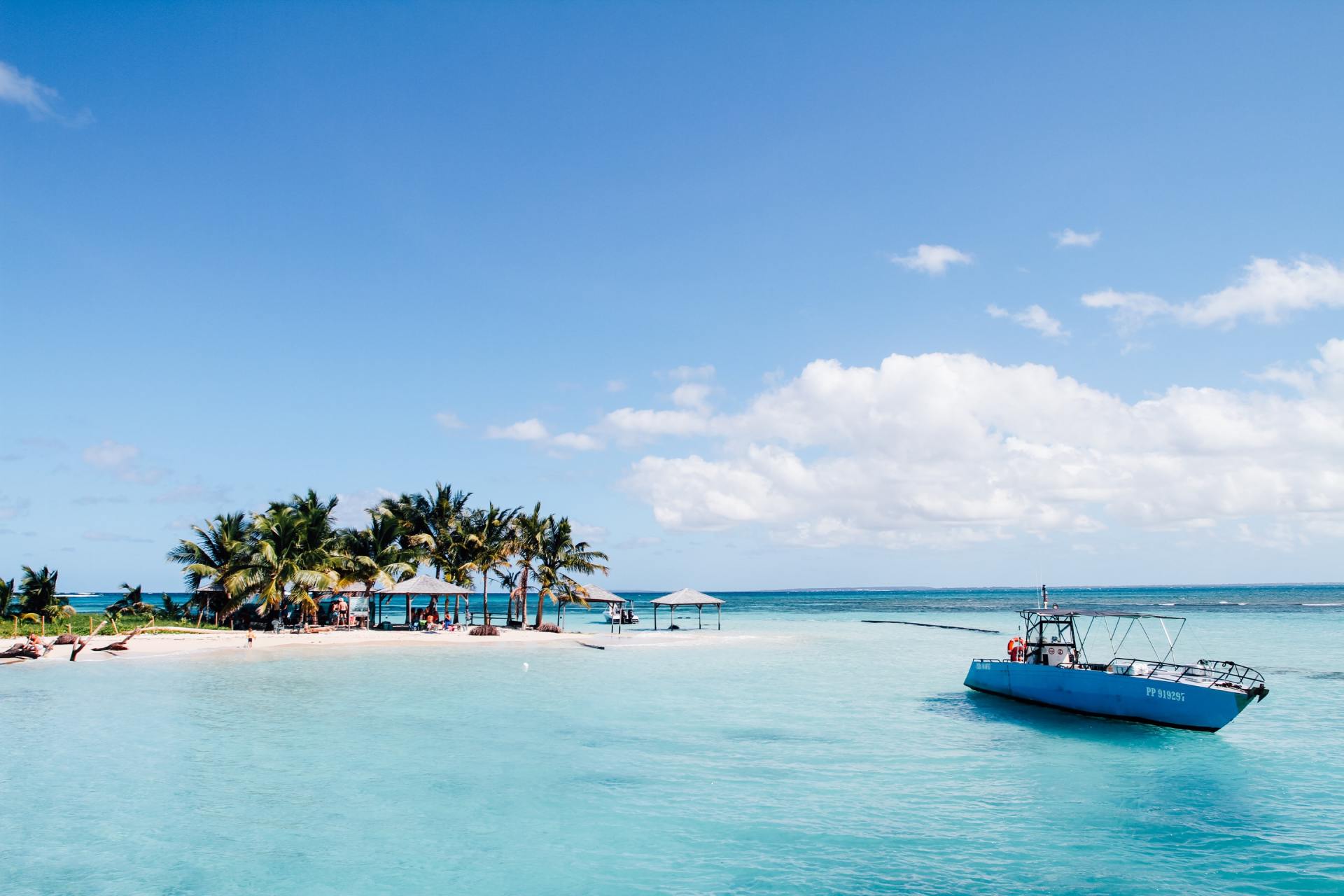 White Sandy beaches of the Caribbean with a moored yacht.