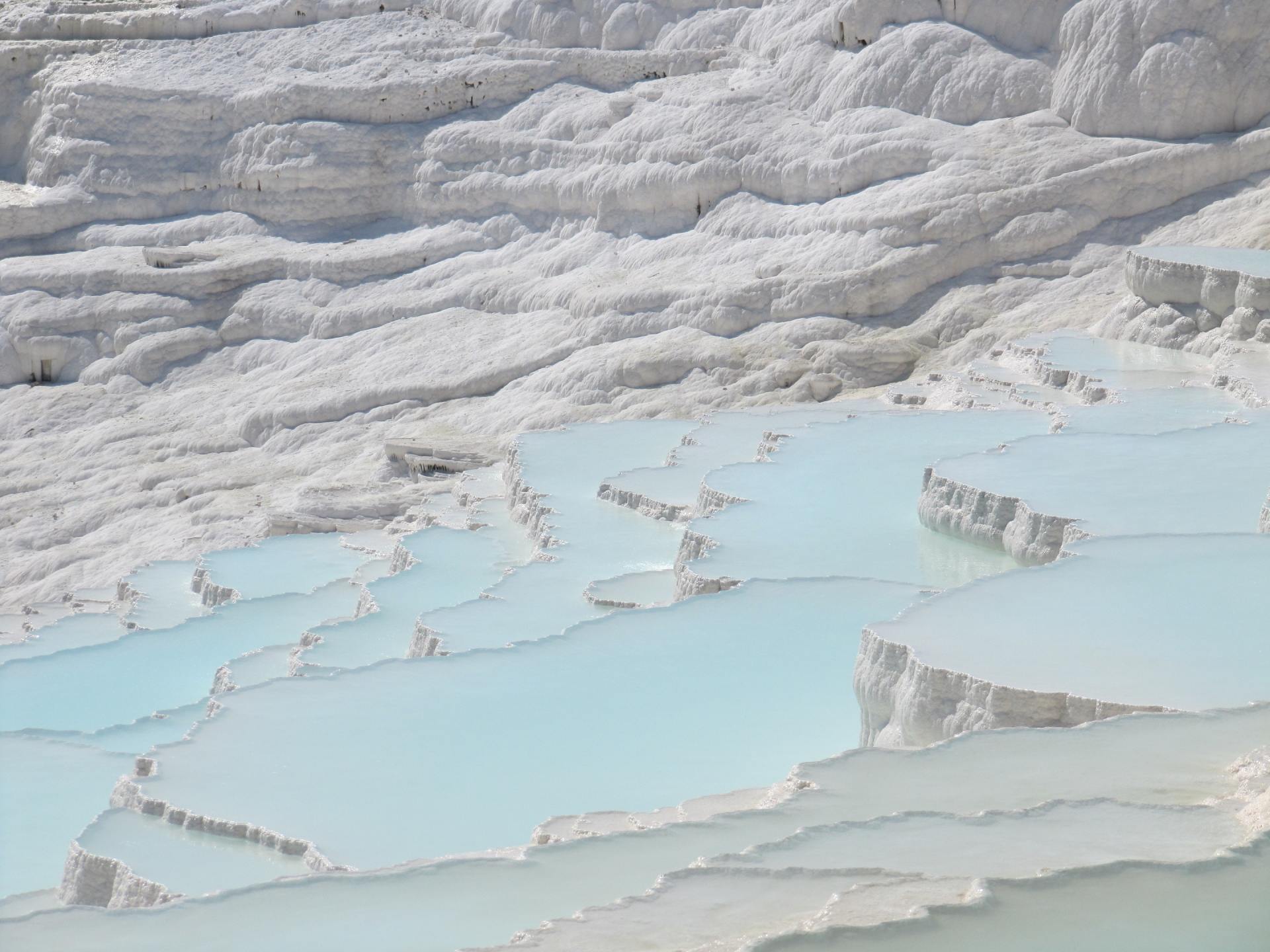 A large body of water surrounded by white rocks.