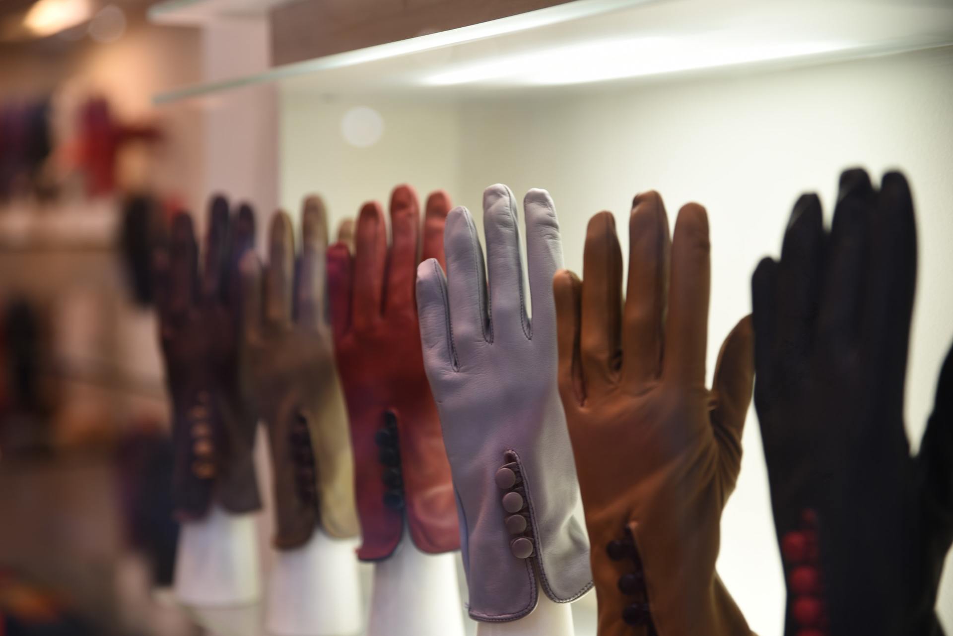 people's hands with different coloured gloves
