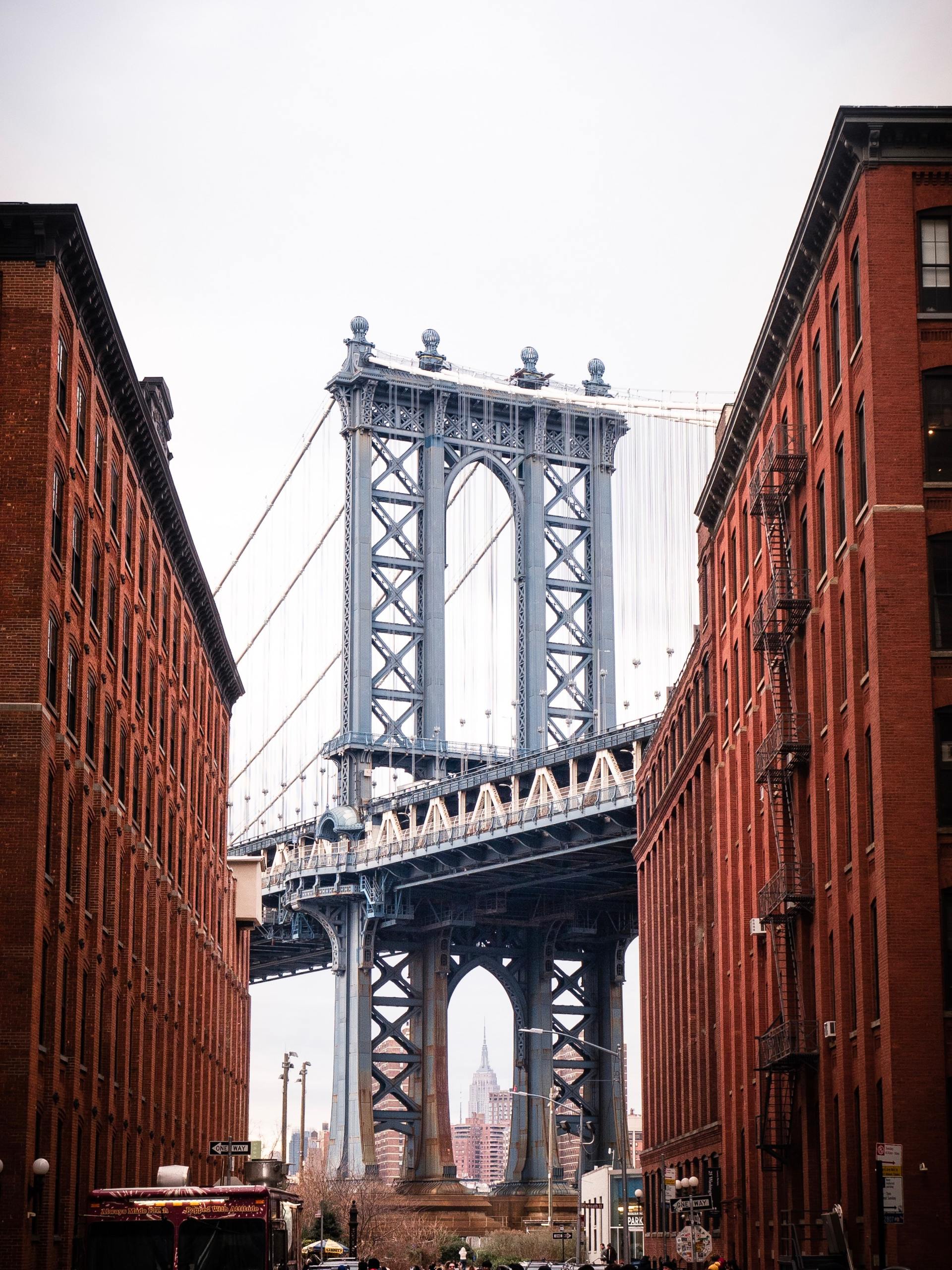 A bridge between two brick buildings in a city