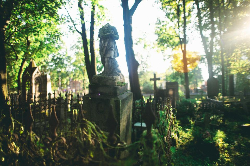 old cemetery with statues and weeds