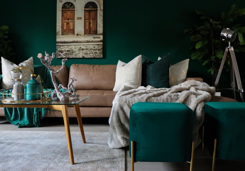 living room with dark green walls and green furniture