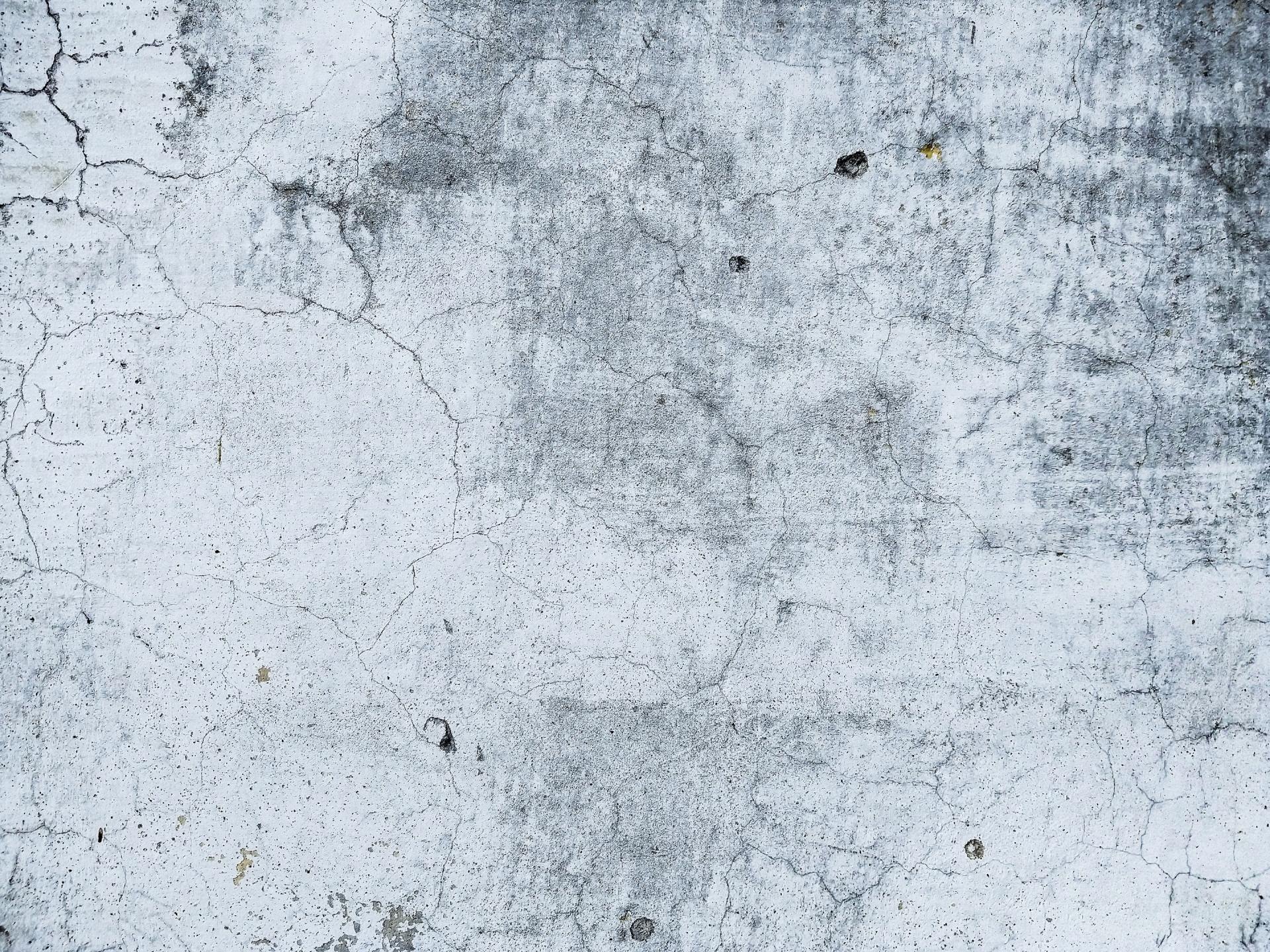 A close up of a white wall with a gray texture.