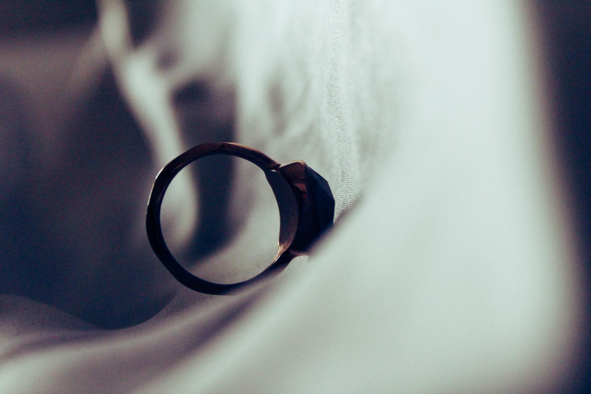 A Close Up of a Wedding Ring on a White Cloth — Warland Solicitors in Port Stephens, NSW