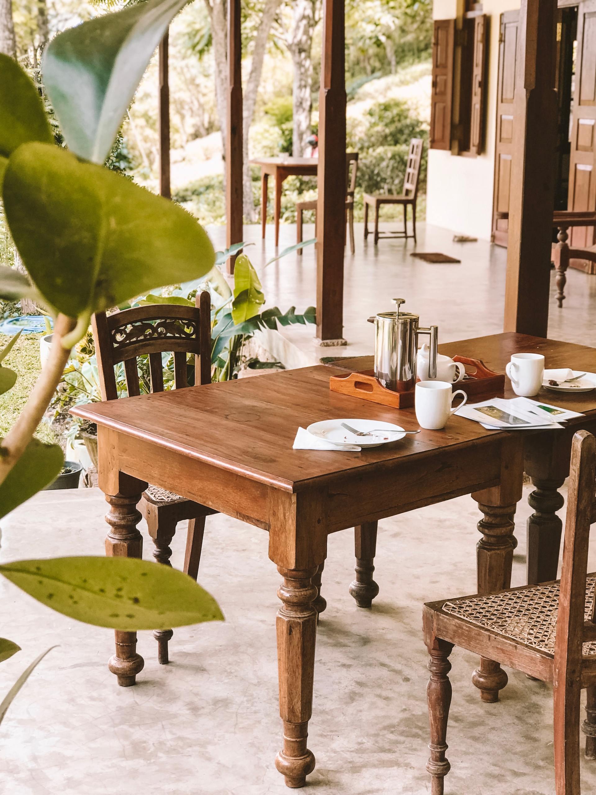 A wooden table with plates and cups on it