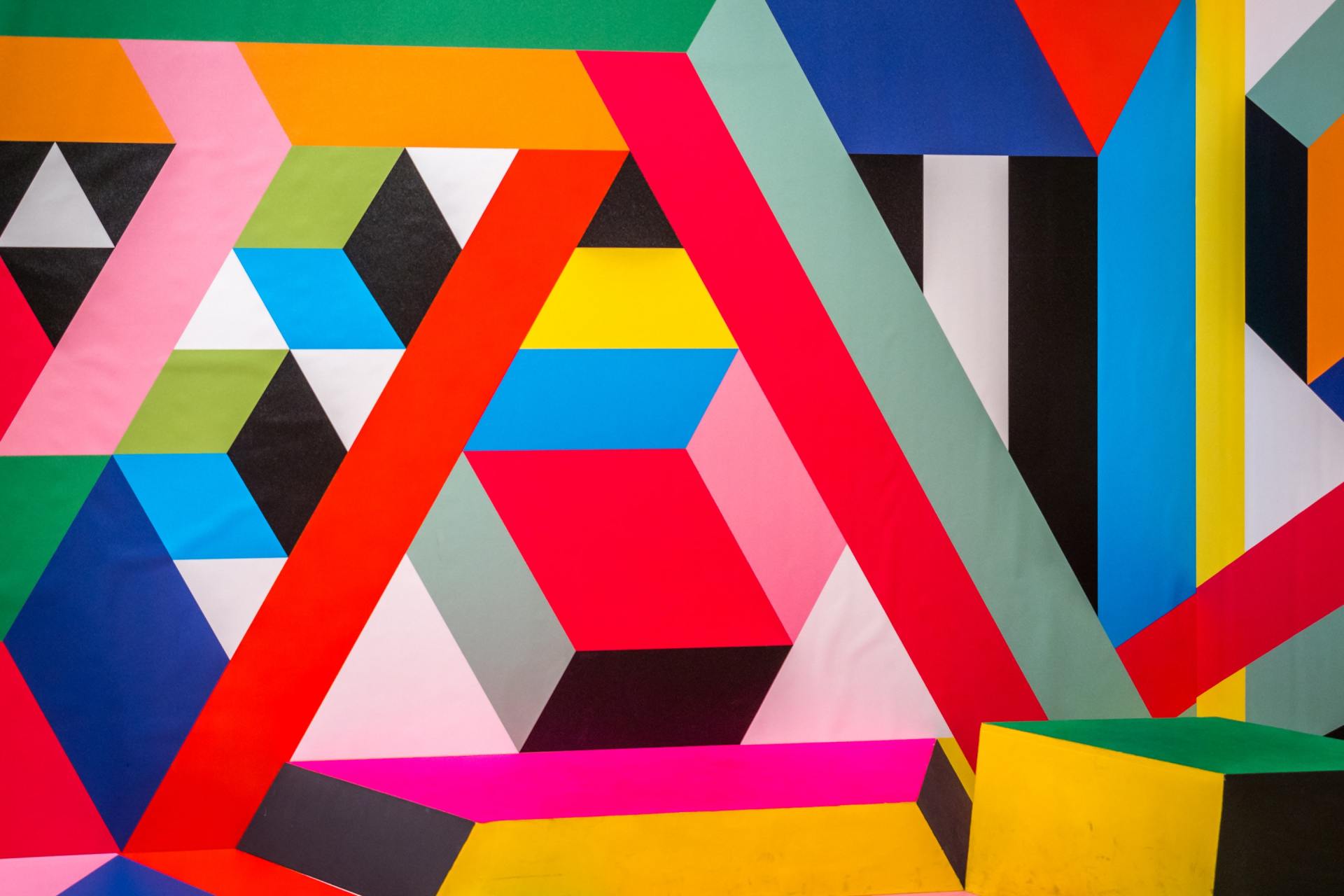 A close up of a colorful geometric pattern on a wall