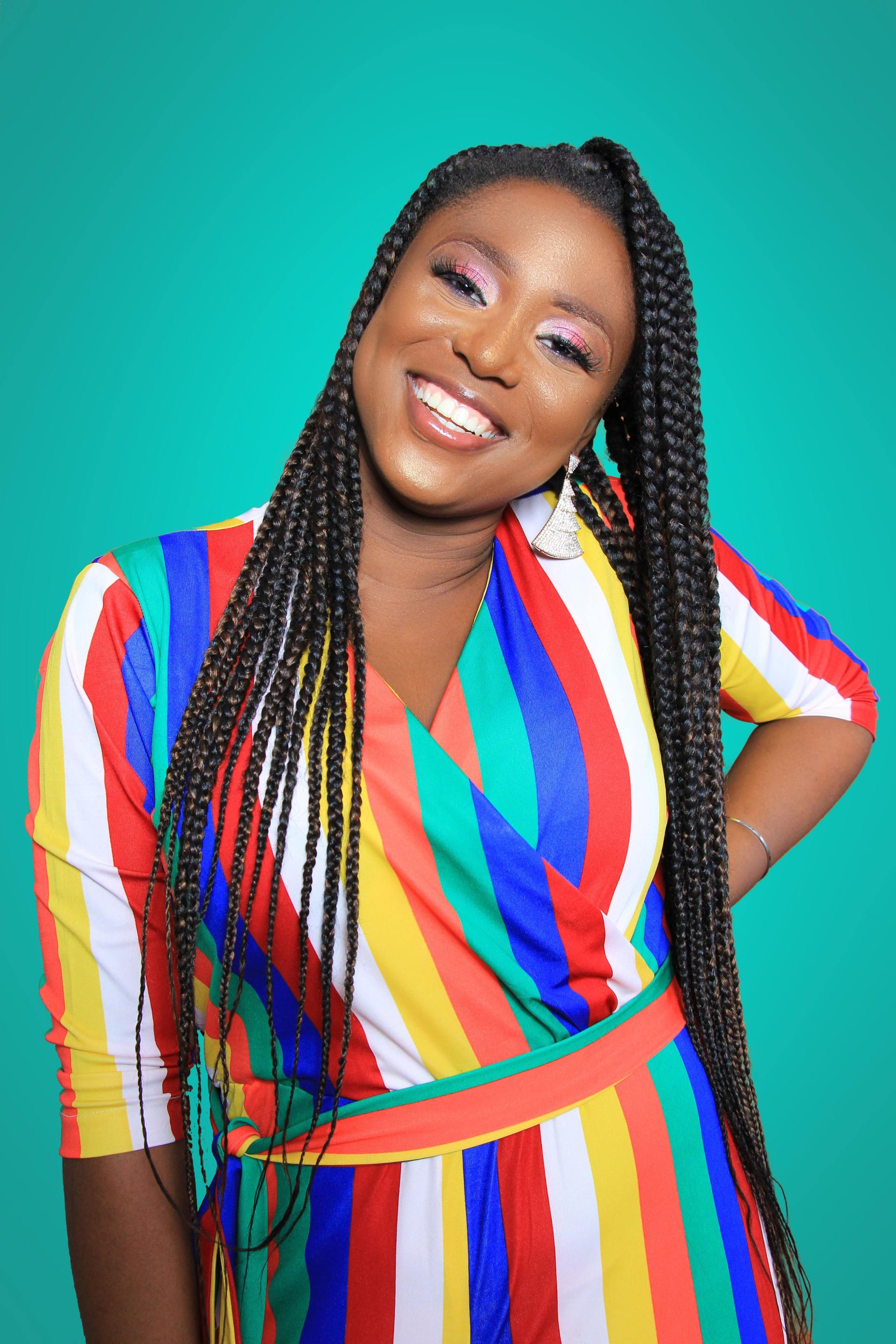 a woman wearing a colorful striped dress smiles for the camera