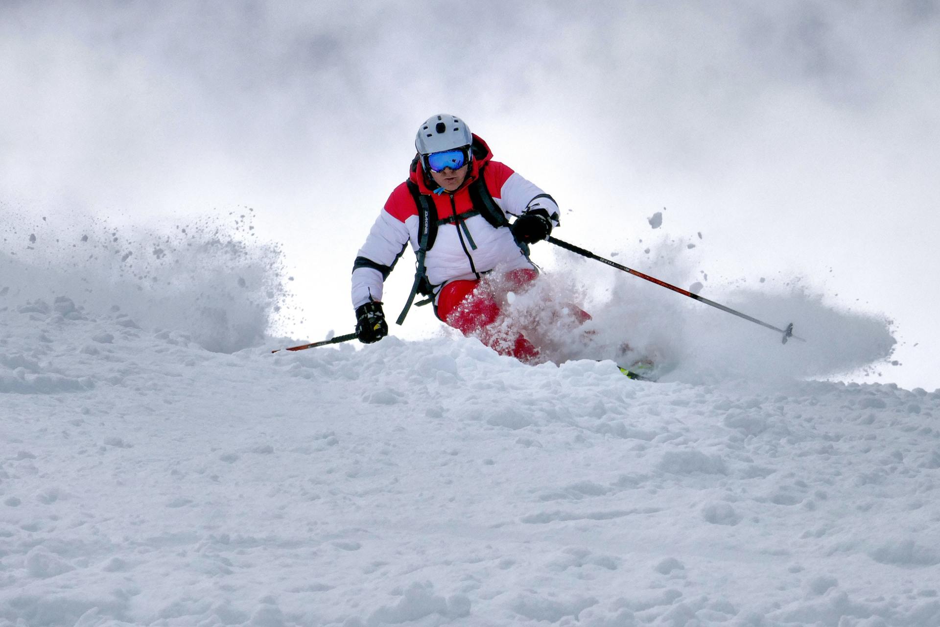 A person is skiing down a snow covered slope