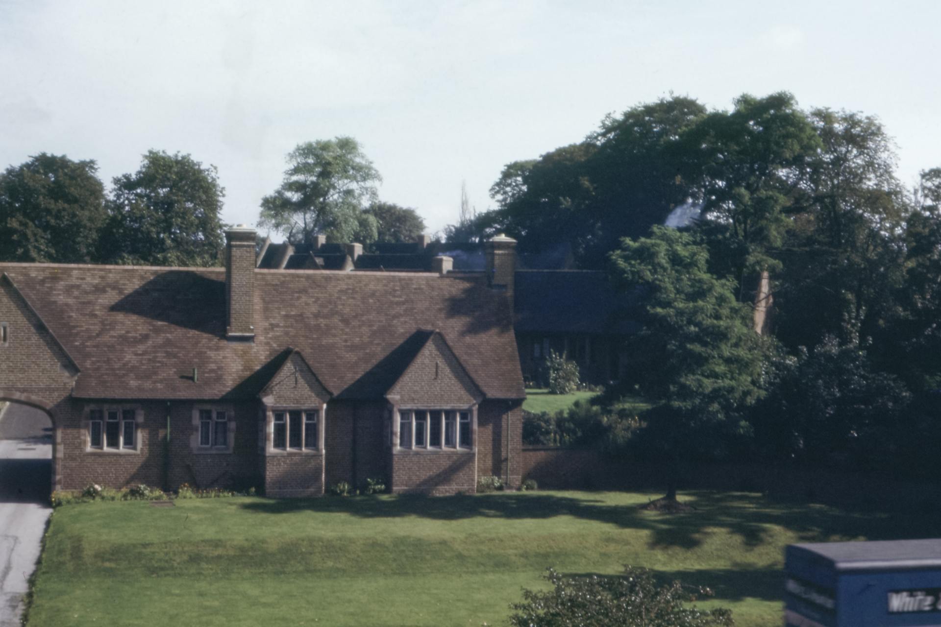 A brick house with a blue box in front of it that says white