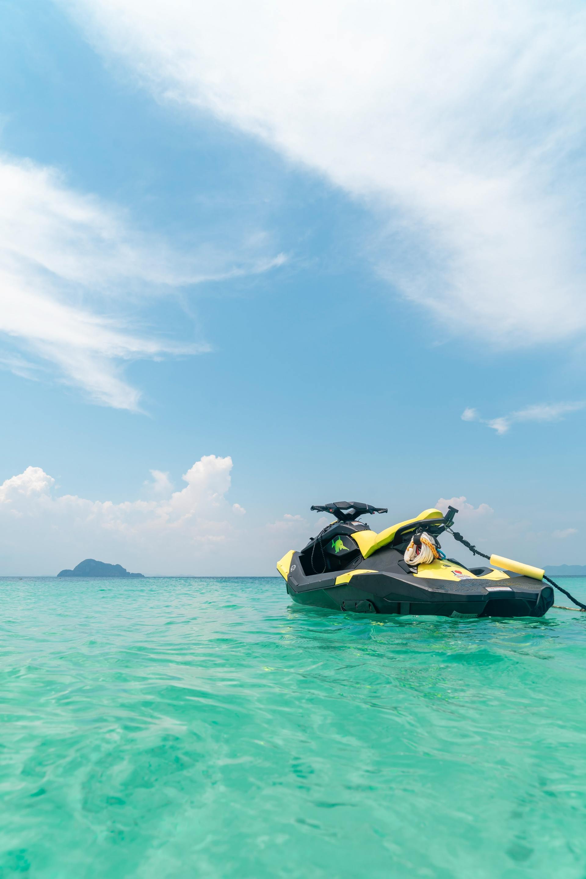 A jet ski is floating on top of a turquoise ocean.