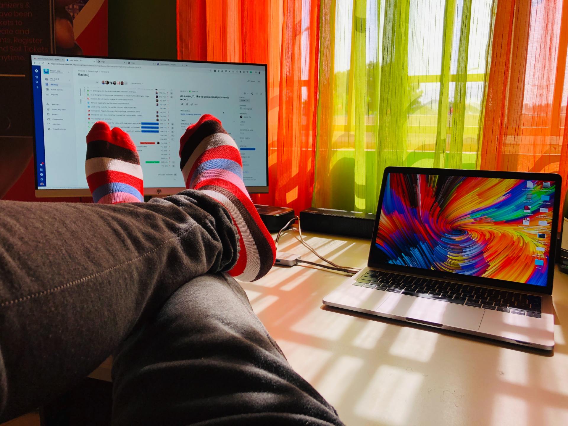 a person with their feet up in front of a laptop computer