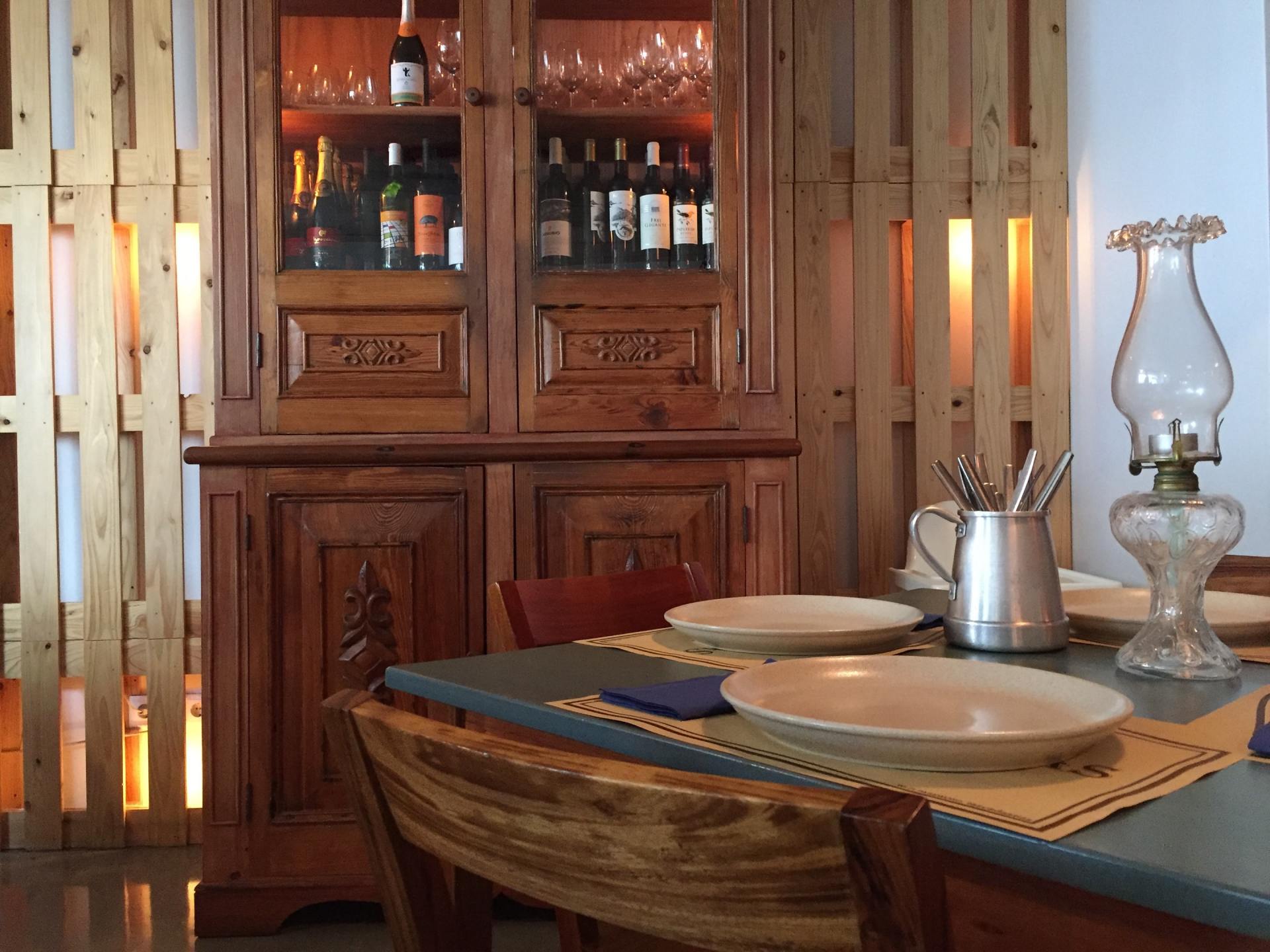 A dining room table with plates and a lamp on it
