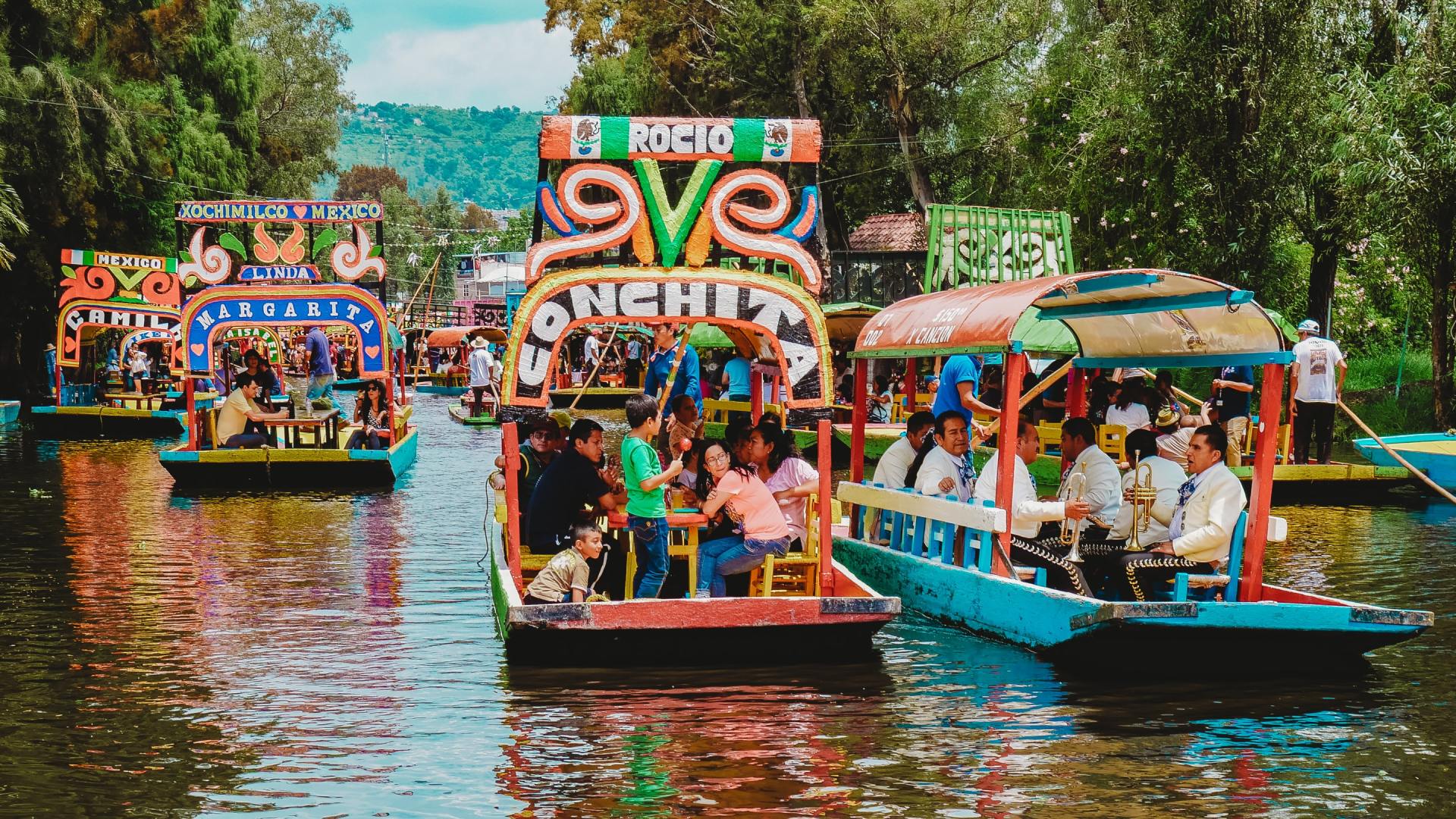 A group of people are riding boats down a river.