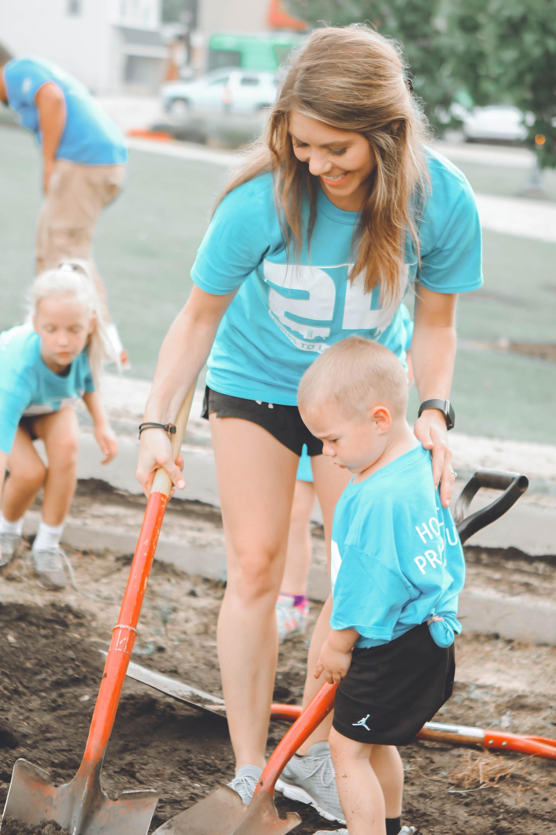 image of women helping young children - Volunteer