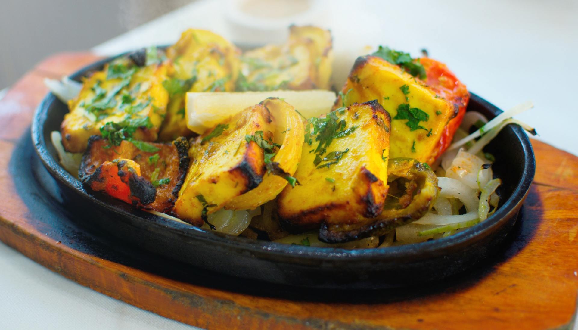 A close up of a plate of food on a wooden cutting board.