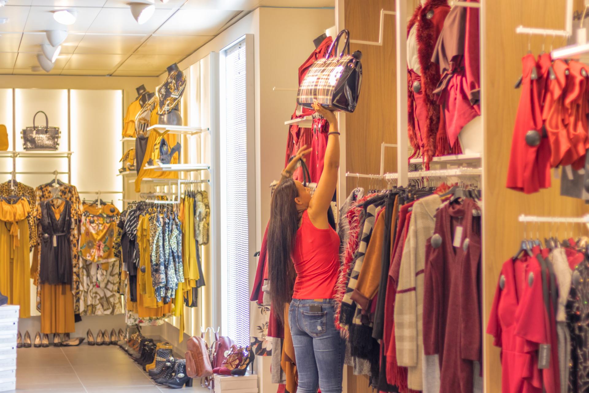 A woman is shopping for clothes in a clothing store.