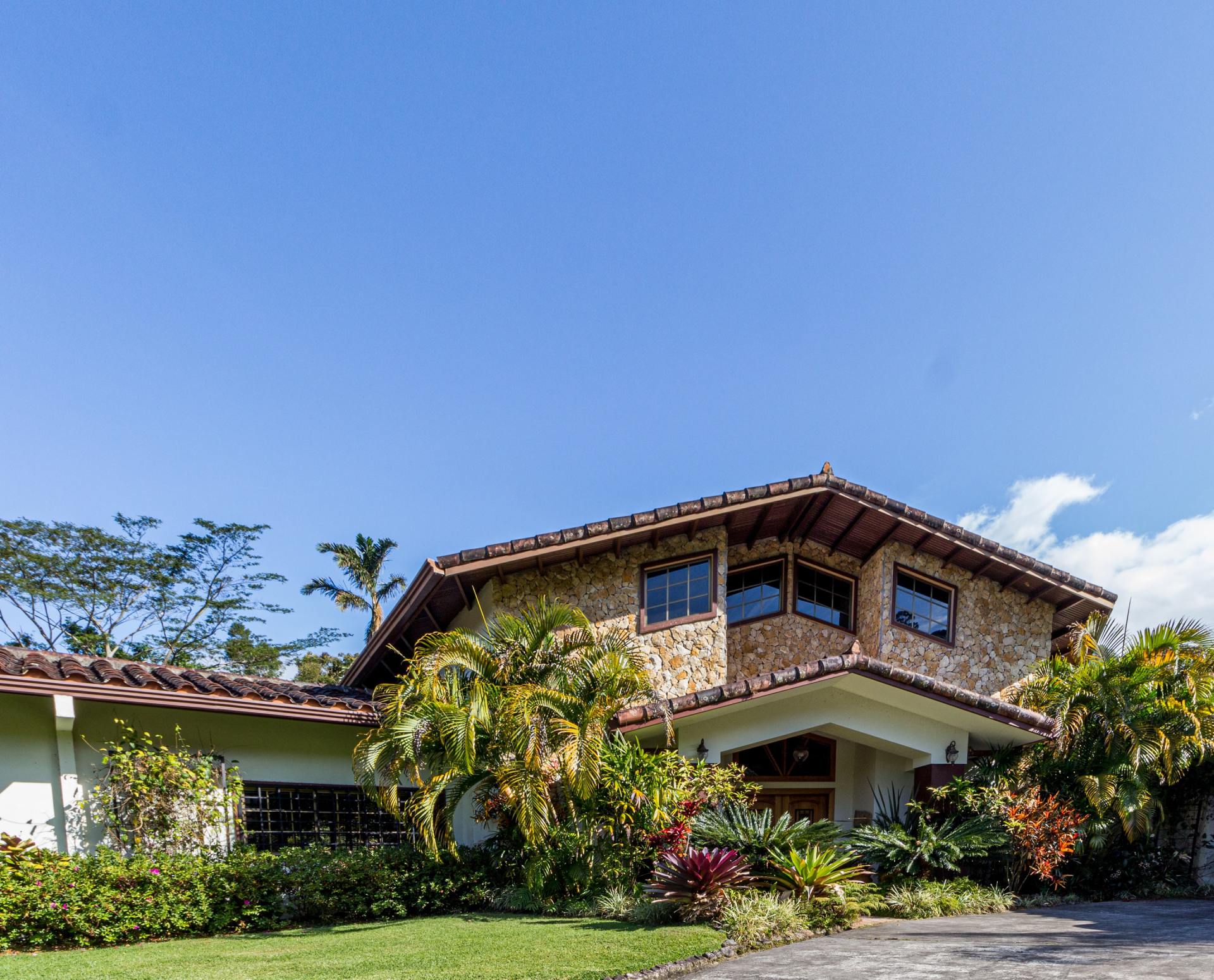A large house with a lot of windows and trees in front of it