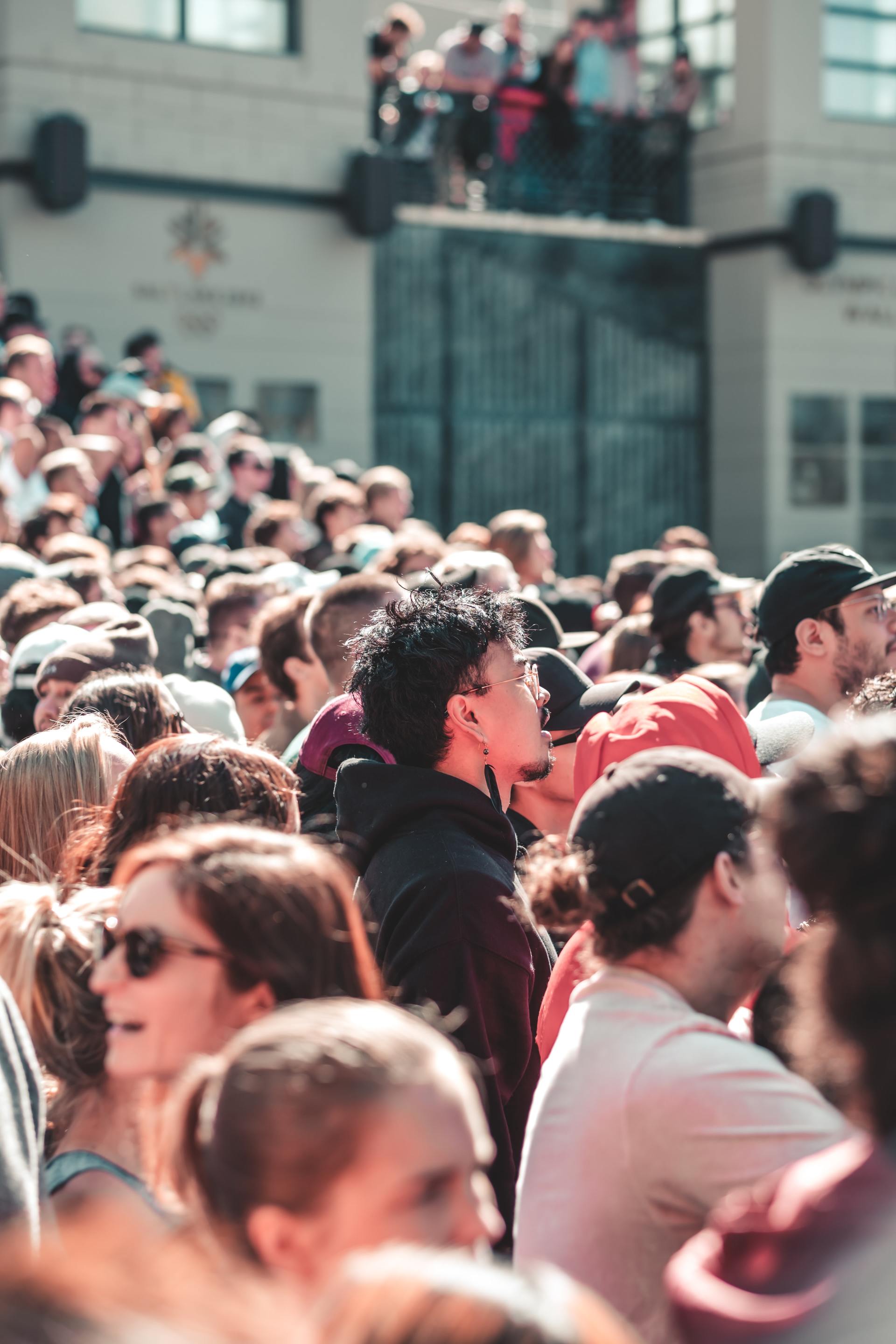 a crowd of people are sitting in a stadium watching a concert .