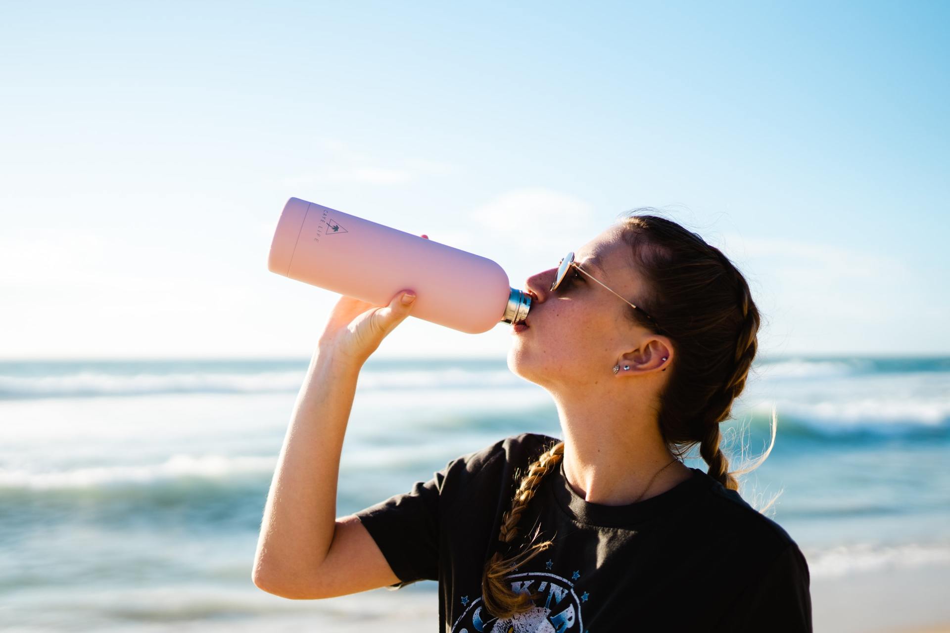 young woman drinking water image