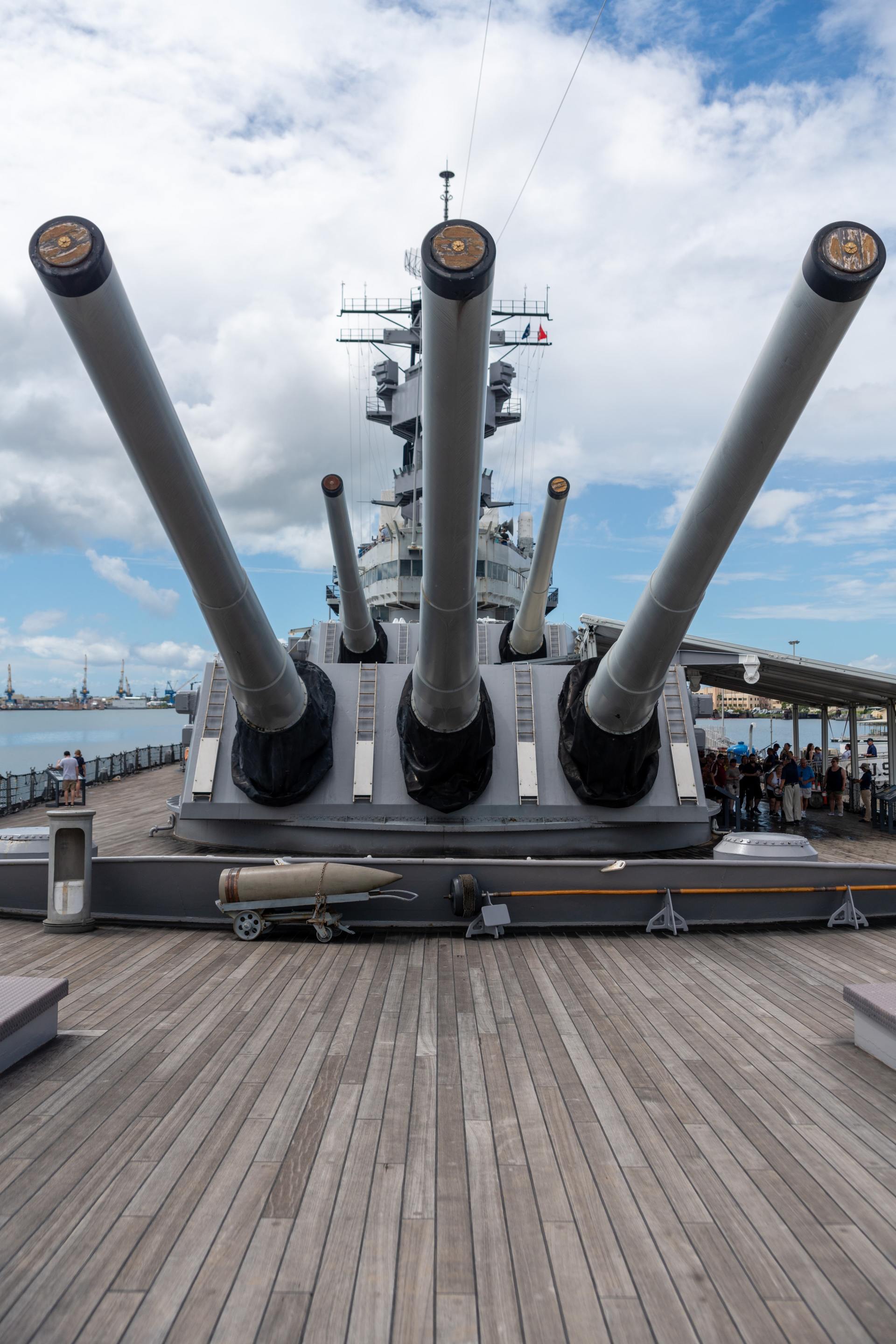 a large battleship with a lot of cannons on the deck .