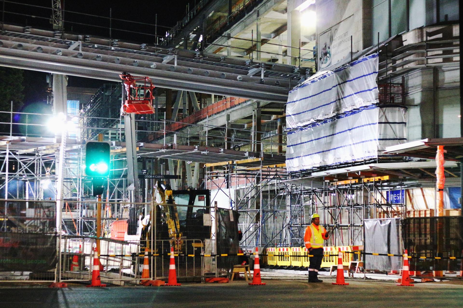 A construction site at night all brightly lit up.