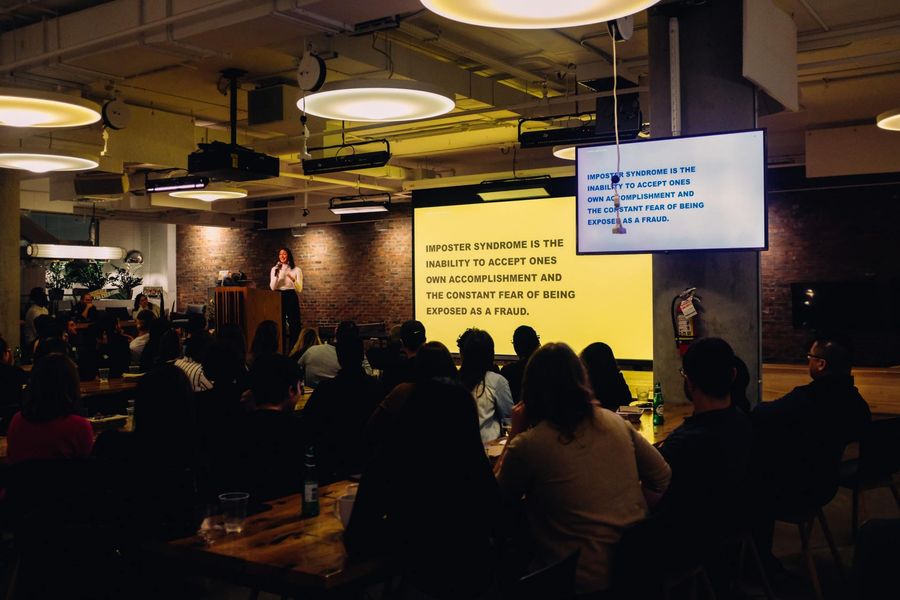 A woman is giving a presentation to a large group of people.