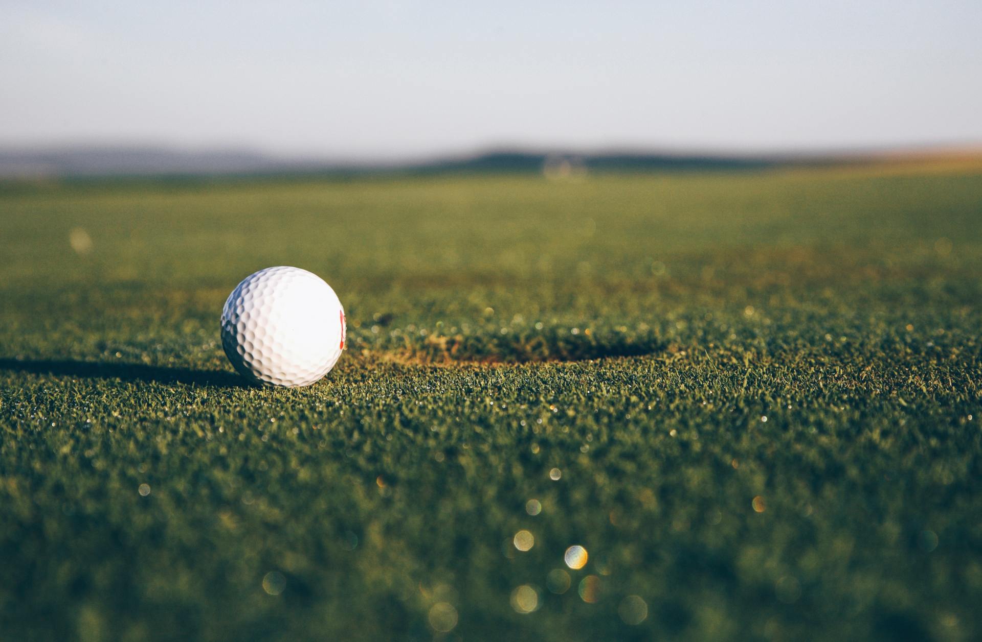 A golf ball is sitting on the green of a golf course.