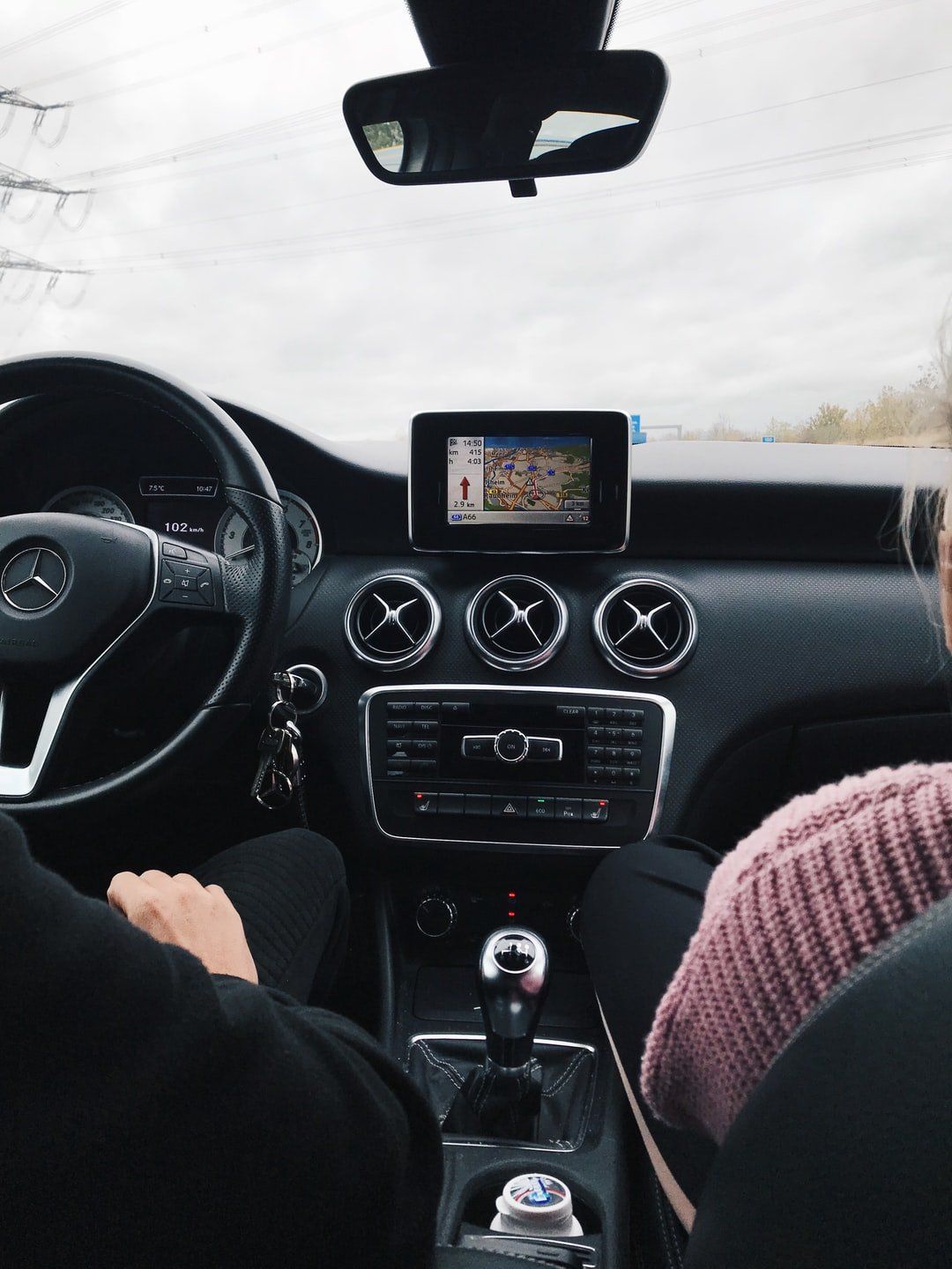A man and a woman are sitting in a car