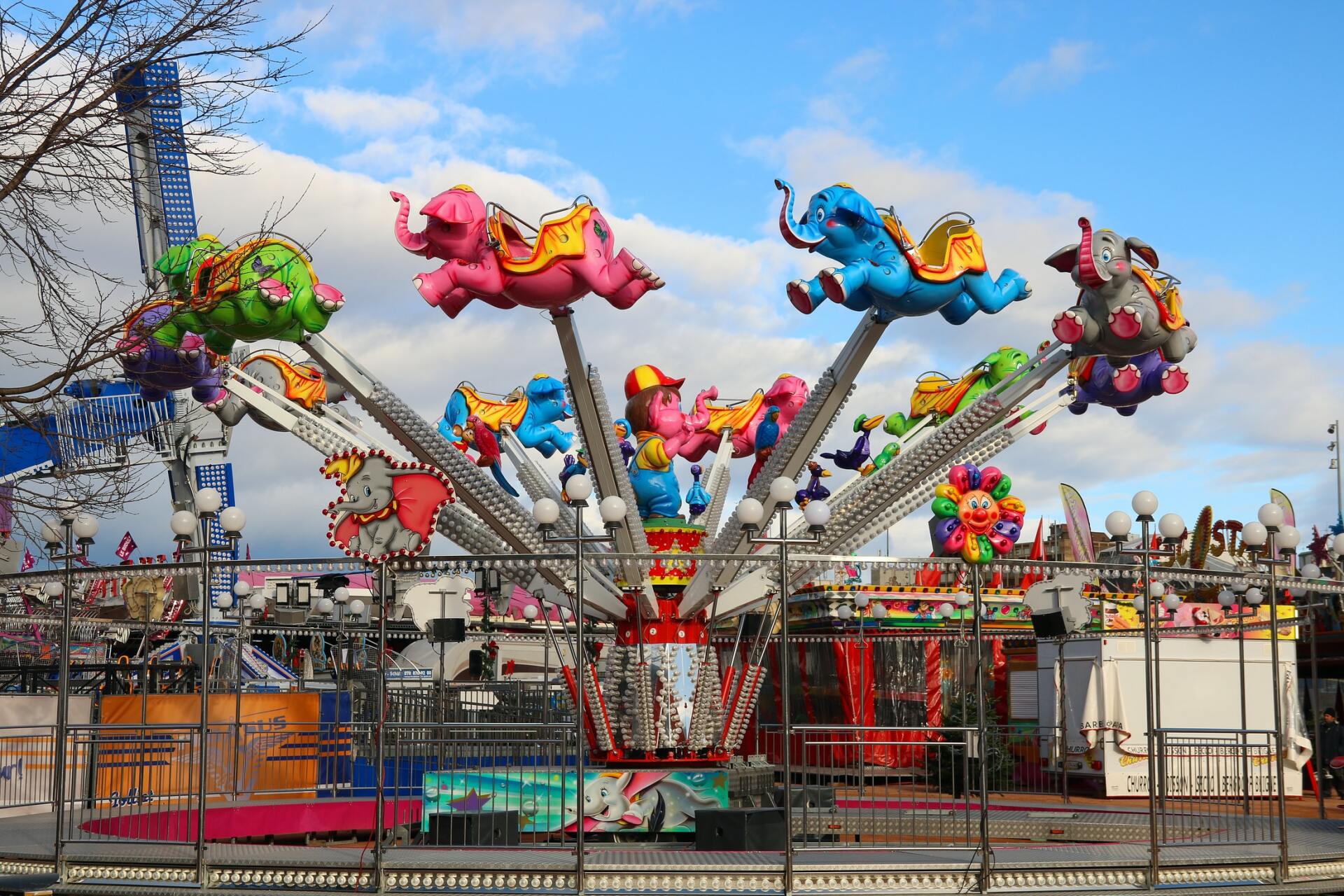 A carnival ride with elephants flying through the air