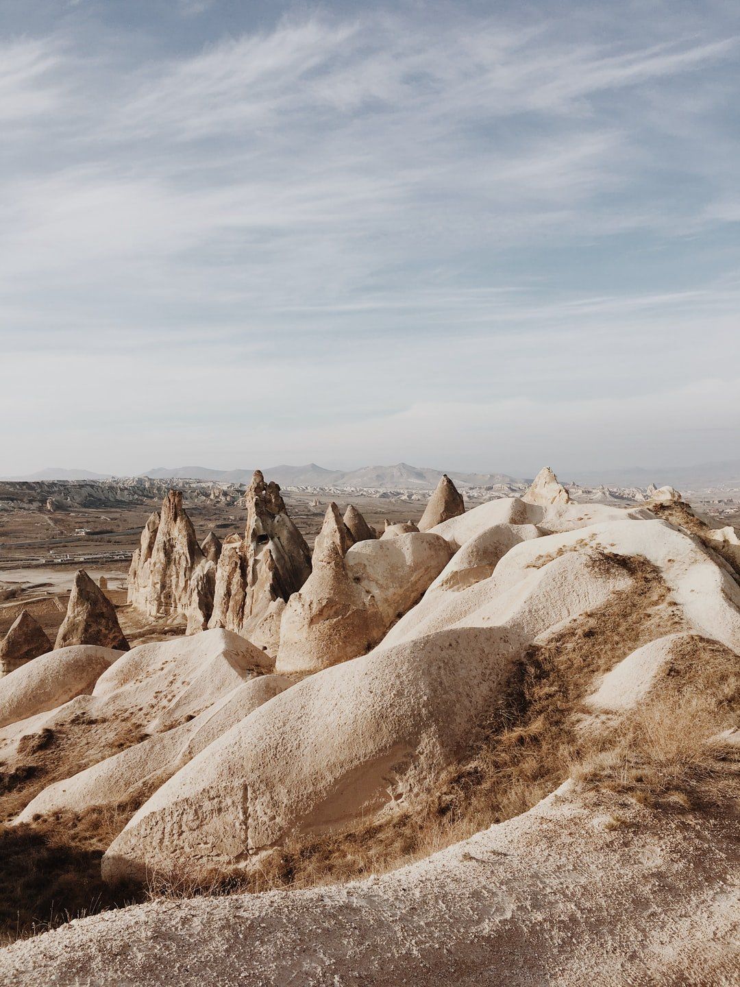A desert landscape with a lot of rocks and mountains in the background