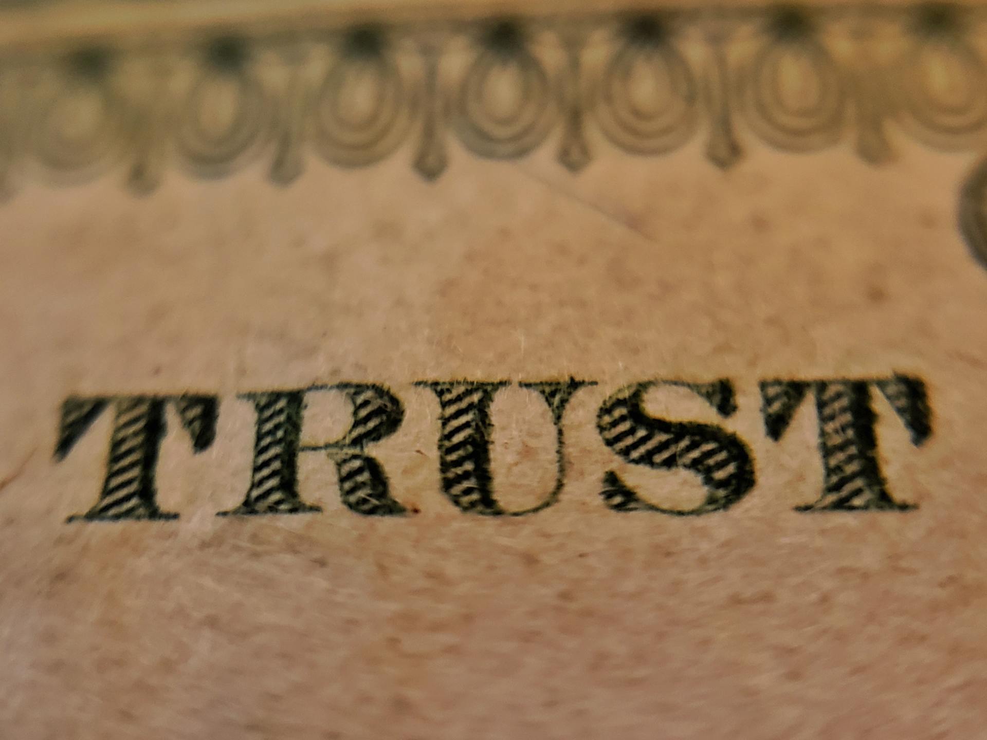 a close up of a dollar bill that says trust