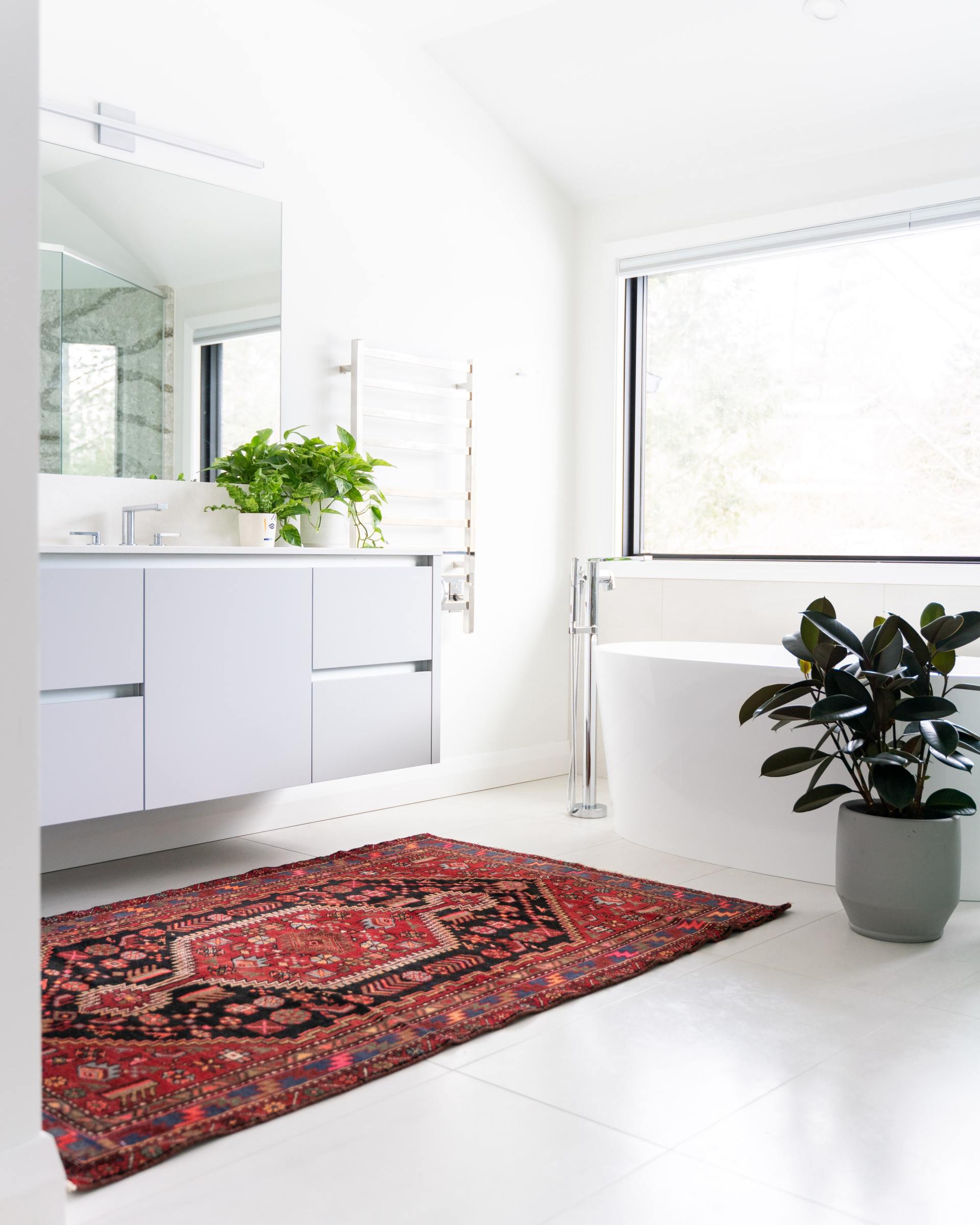 Floating White Vanity with Warm Persian Rug in Modern Bathroom