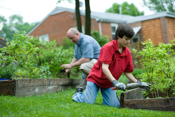 An adult and child gardening together