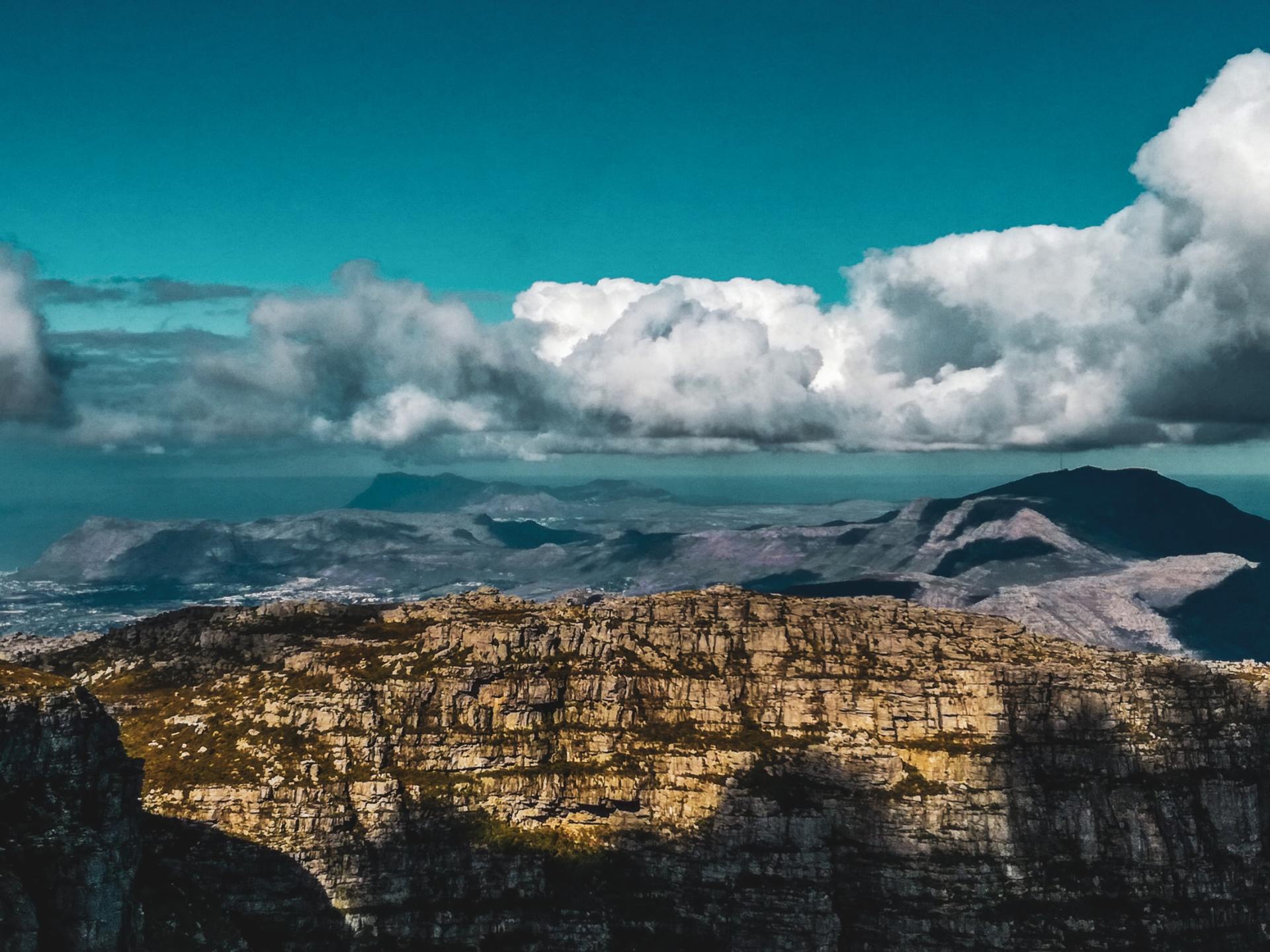 A view of a mountain range with clouds in the sky
