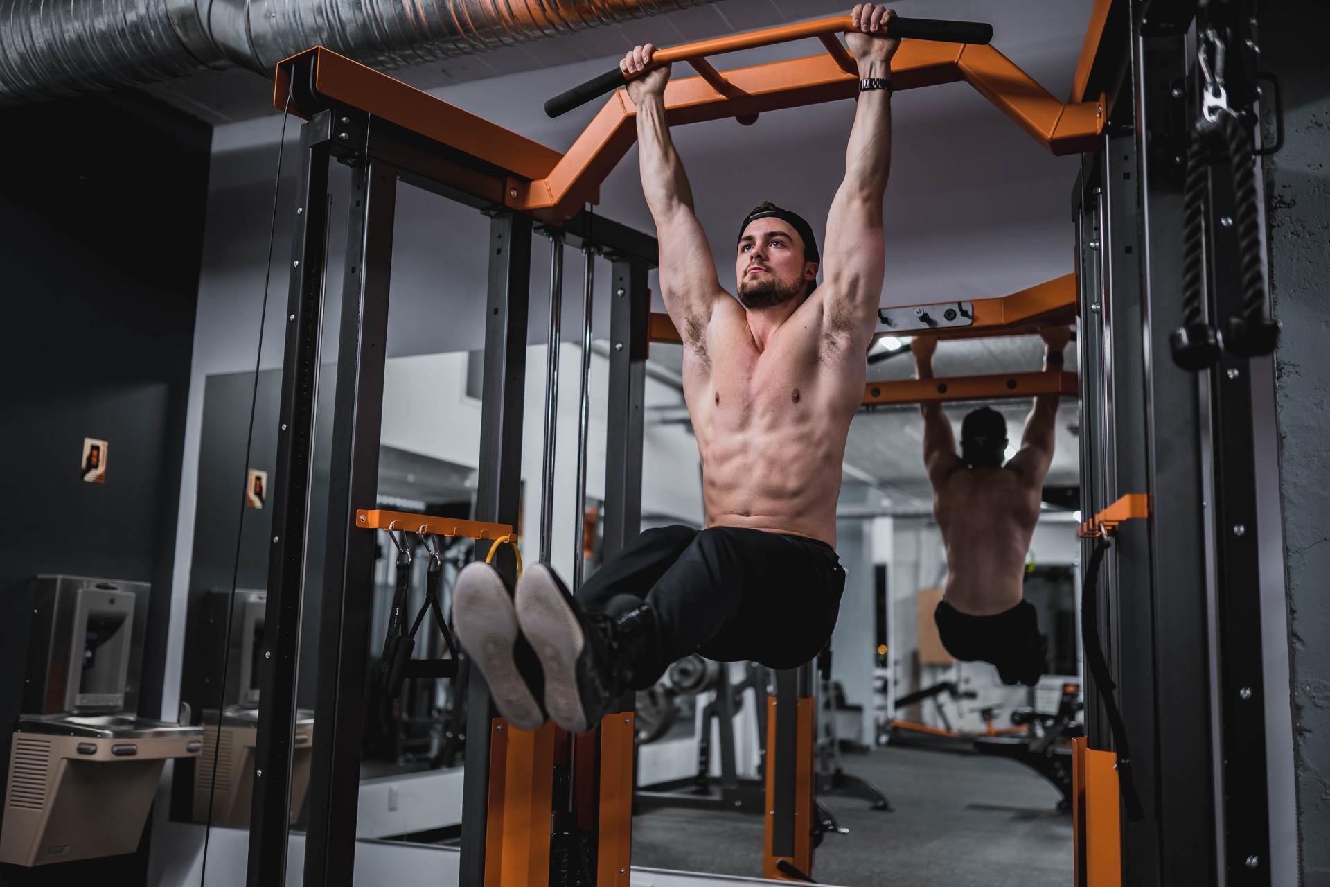 Image of Muscular Male Exercising in Gym, Doing Abdominal Exercises