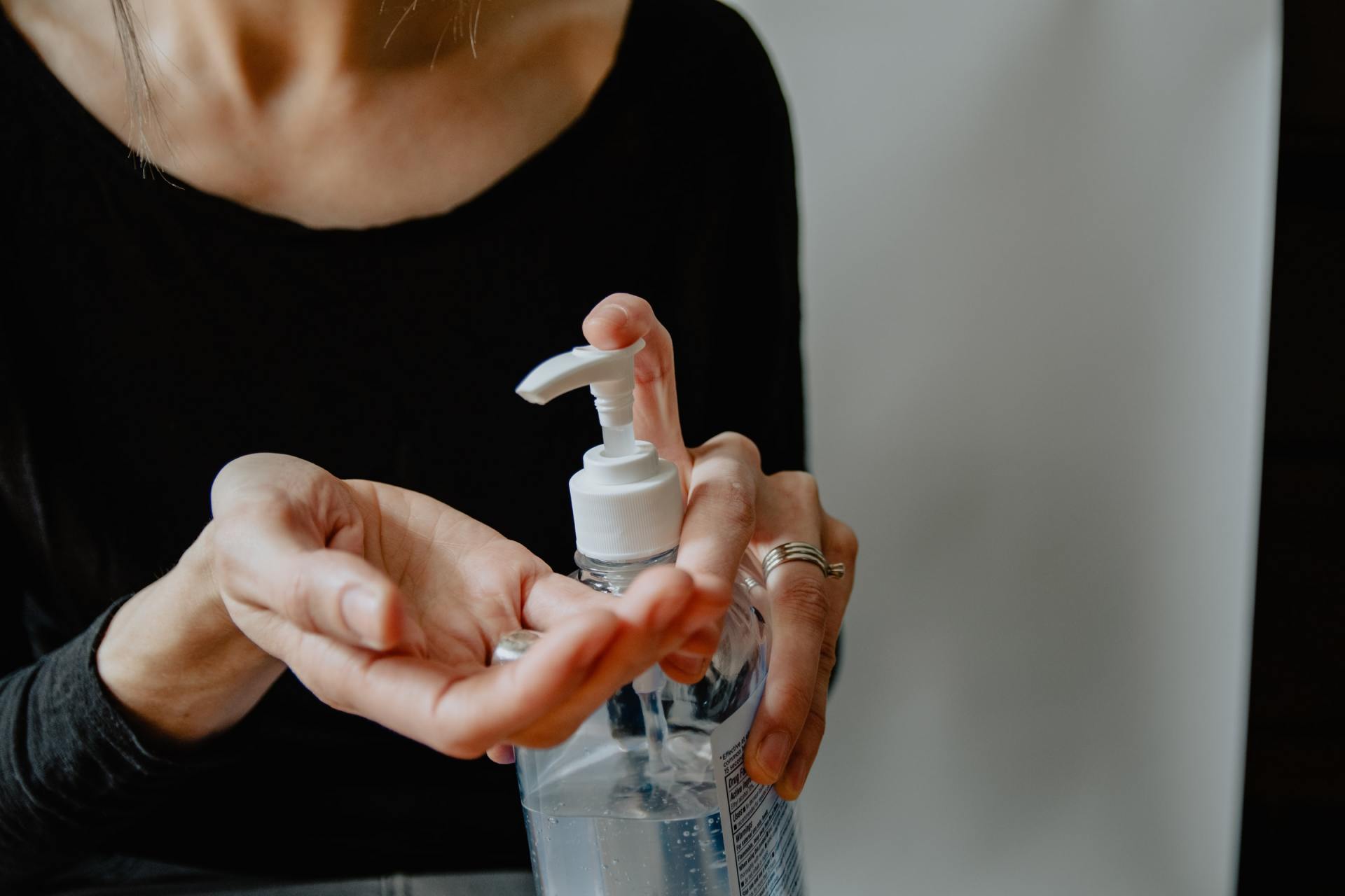 Woman applying hand sanitizer.