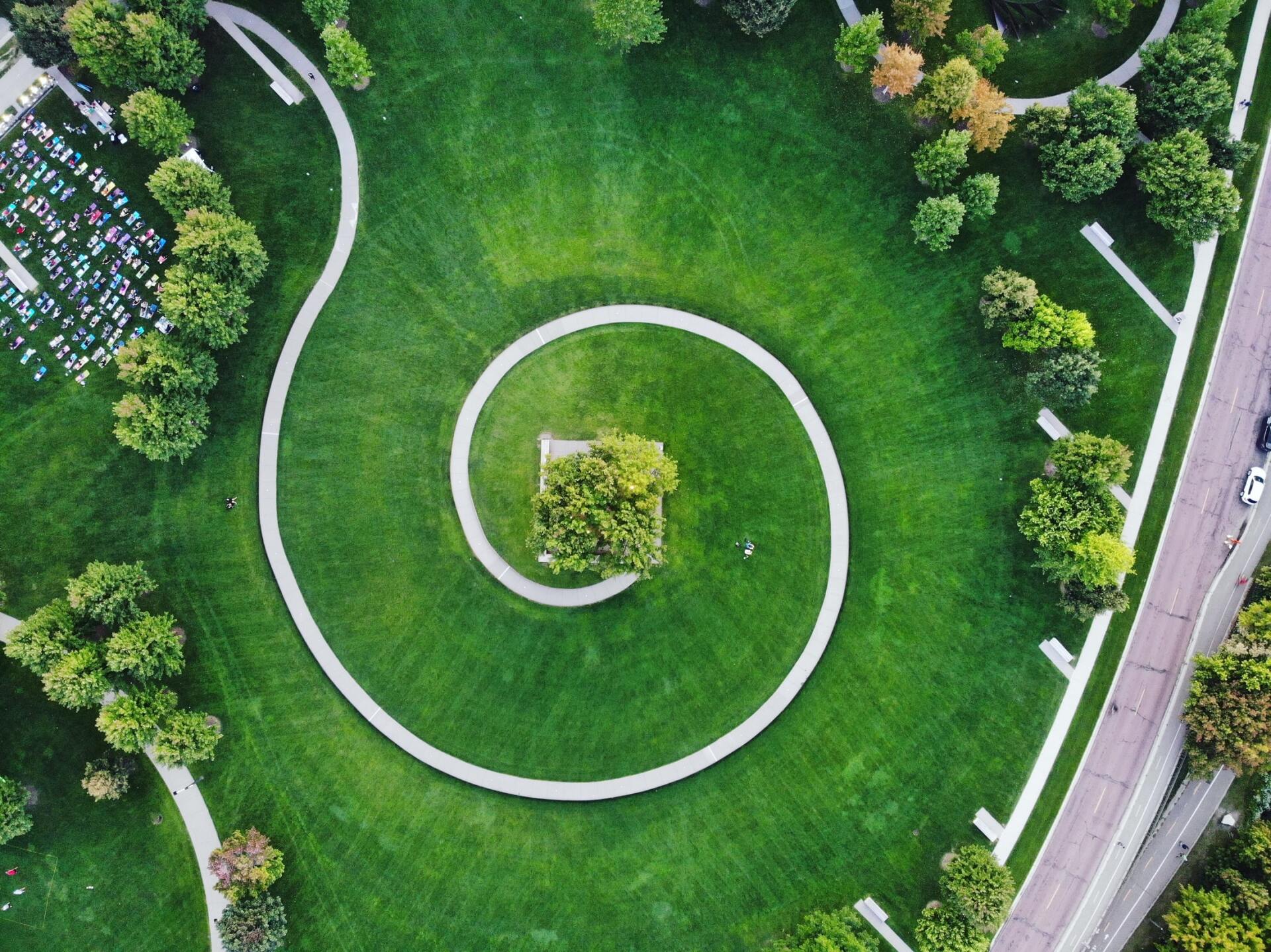 An aerial view of a park with a spiral in the middle of it.