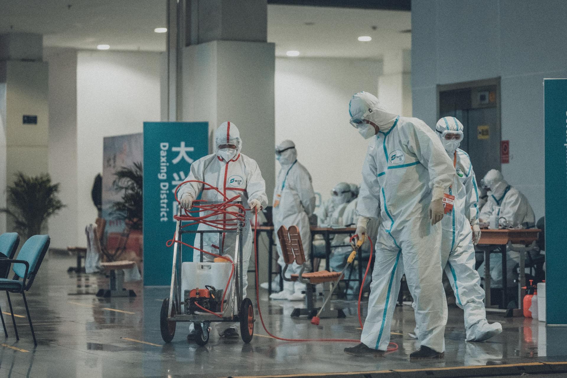 Medical workers in hazmat type looking suits to protect themselves